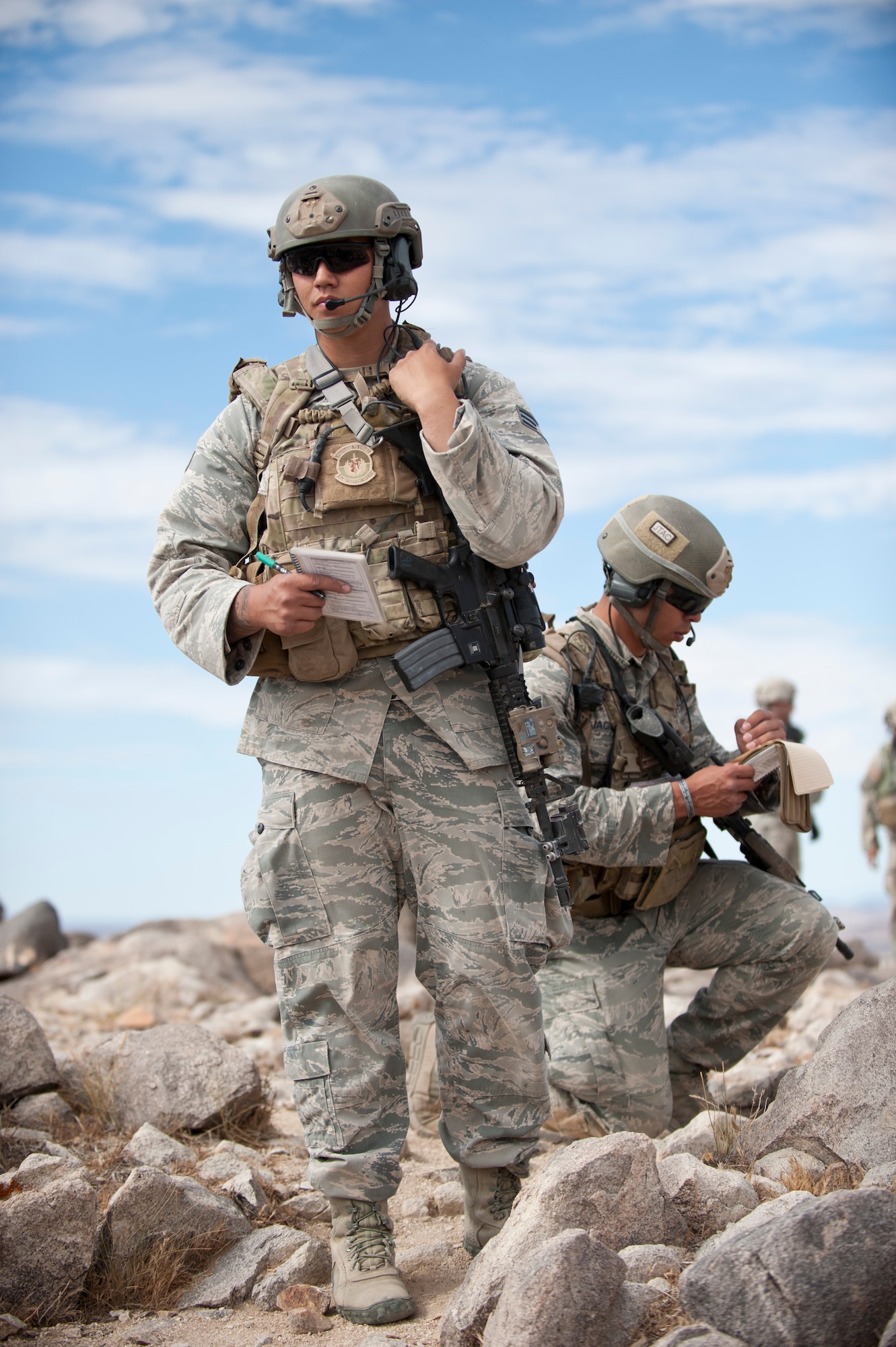 Joint terminal attack controllers assigned to the 7th Air Support Operations Squadron, Fort Bliss, Texas, use radios to direct the pilot of an F-16 Fighting Falcon towards designated targets during a Green Flag 15-08 training scenario at the National Training Center, Fort Irwin, Calif., June 12, 2015. The JTACs pictured are conducting a “talk on” during which, a controller communicates navigational information as well as calls for fire to a pilot in the air in order to support the needs of a ground commander. (U.S. Air Force photo by Senior Airman Joshua Kleinholz)