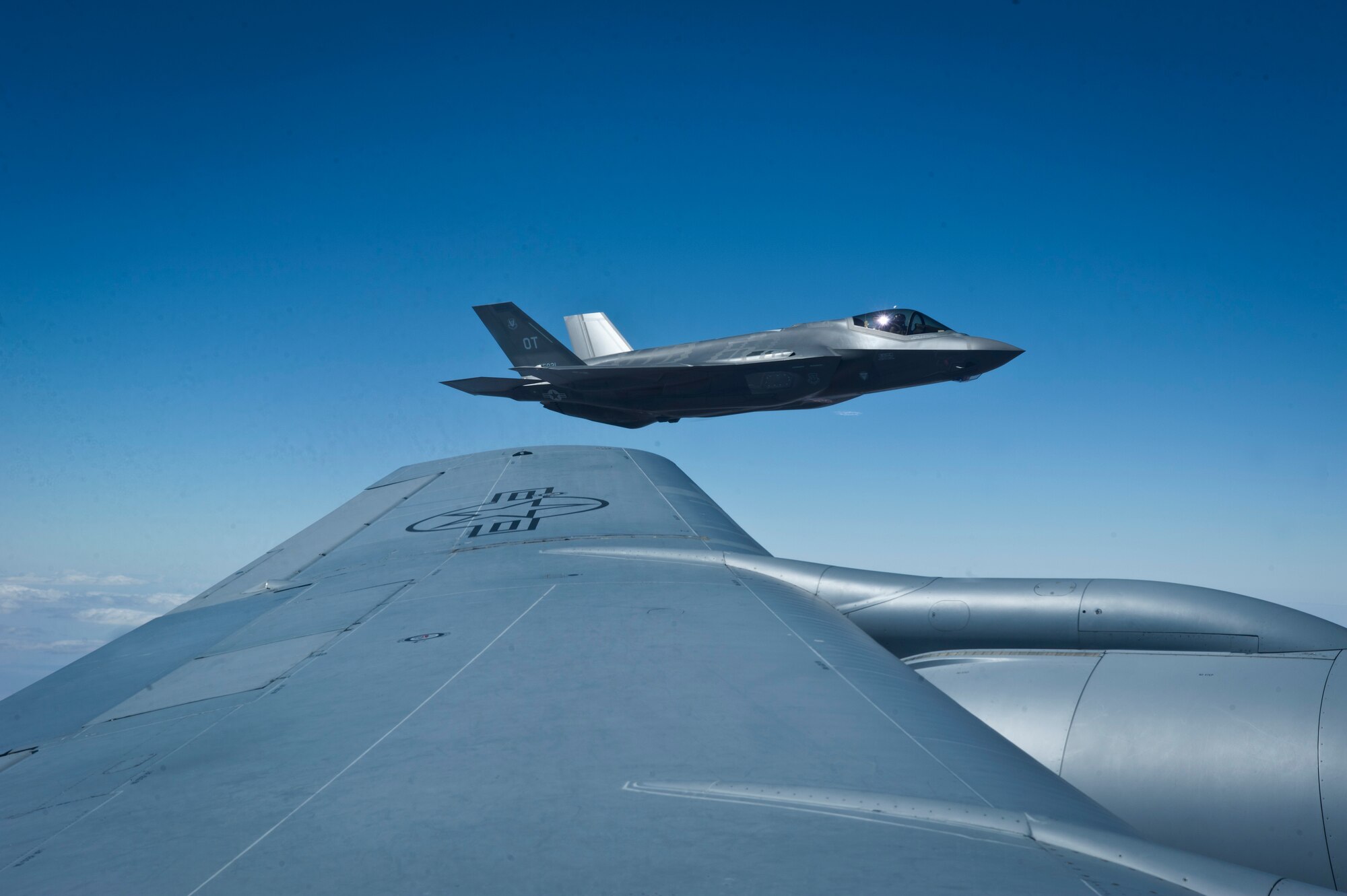 An F-35A Lightning II assigned to the 31st Test and Evaluation Squadron, Edwards Air Force Base, Calif., waits off the wing of a KC-135 Stratotanker assigned to the 927th Air Refueling Wing, MacDill AFB, Fla., after refueling during a Green Flag 15-08 training sortie in the skies over the National Training Center, Calif., June 10, 2015. The F-35 is the Department of Defense's focal point for defining affordable next generation strike aircraft weapon systems for the Navy, Air Force, Marines, and world allies. (U.S. Air Force photo by Senior Airman Joshua Kleinholz)