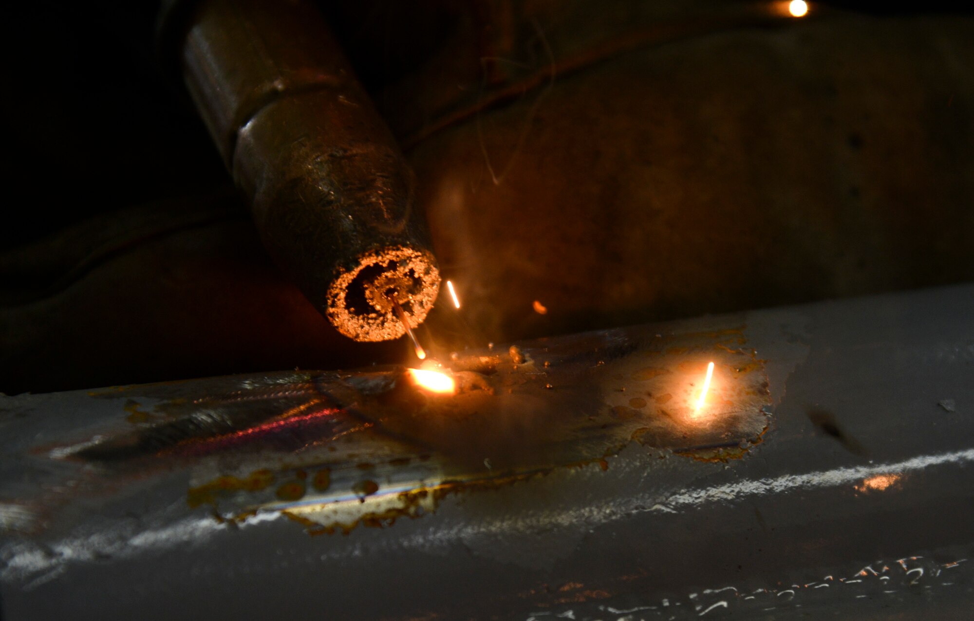 Airman 1st Class Curtis Doherty, 374th Maintenance Squadron aircraft metals technology journeyman, welds a post hole for a B-1 platform in the fabrication shop at Yokota Air Base, Japan, June 23, 2015. The metal technology shop works on 20 to 80 pieces of equipment each week. (U.S. Air Force photo by Senior Airman David Owsianka/Released)