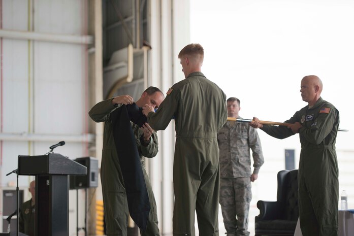 Colonel Fred Boehm places a protective case over the 17th Airlift Squadron's guidon flag officially retiring it during the squadron's inactivation ceremony June 25, 2015 at Joint Base Charleston, S.C. As part of the President’s Defense Budget for FY15, one of Charleston’s four active-duty C-17 flying squadron's was designated for inactivation. In attendance at the ceremony were many of the squadron's former commander's including Maj. Gen. (ret) Ron Ladnier, who commanded the squadron when it stood up as the first operational C-17 squadron. Boehm is the 437th Operations Group commander. (U.S. Air Force photo / Trisha Gallaway) 
