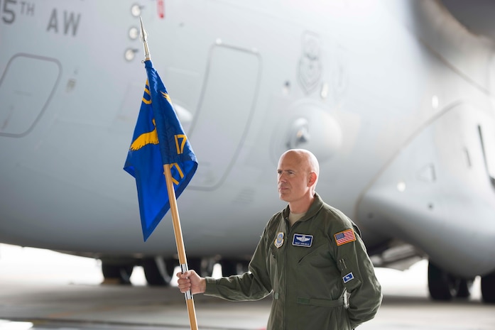 Chief Master Sgt. John Gallo bears the guidon during the 17th Airlift Squadron's inactivation ceremony June 25, 2015 at Joint Base Charleston, S.C. As part of the President’s Defense Budget for FY15, one of Charleston’s four active-duty C-17 flying squadron's was designated for inactivation. In attendance at the ceremony were many of the squadron's former commander's including Maj. Gen. (ret) Ron Ladnier, who commanded the squadron when it stood up as the first operational C-17 squadron. Gallo is the 17th AS superintendent. (U.S. Air Force photo / Trisha Gallaway)  