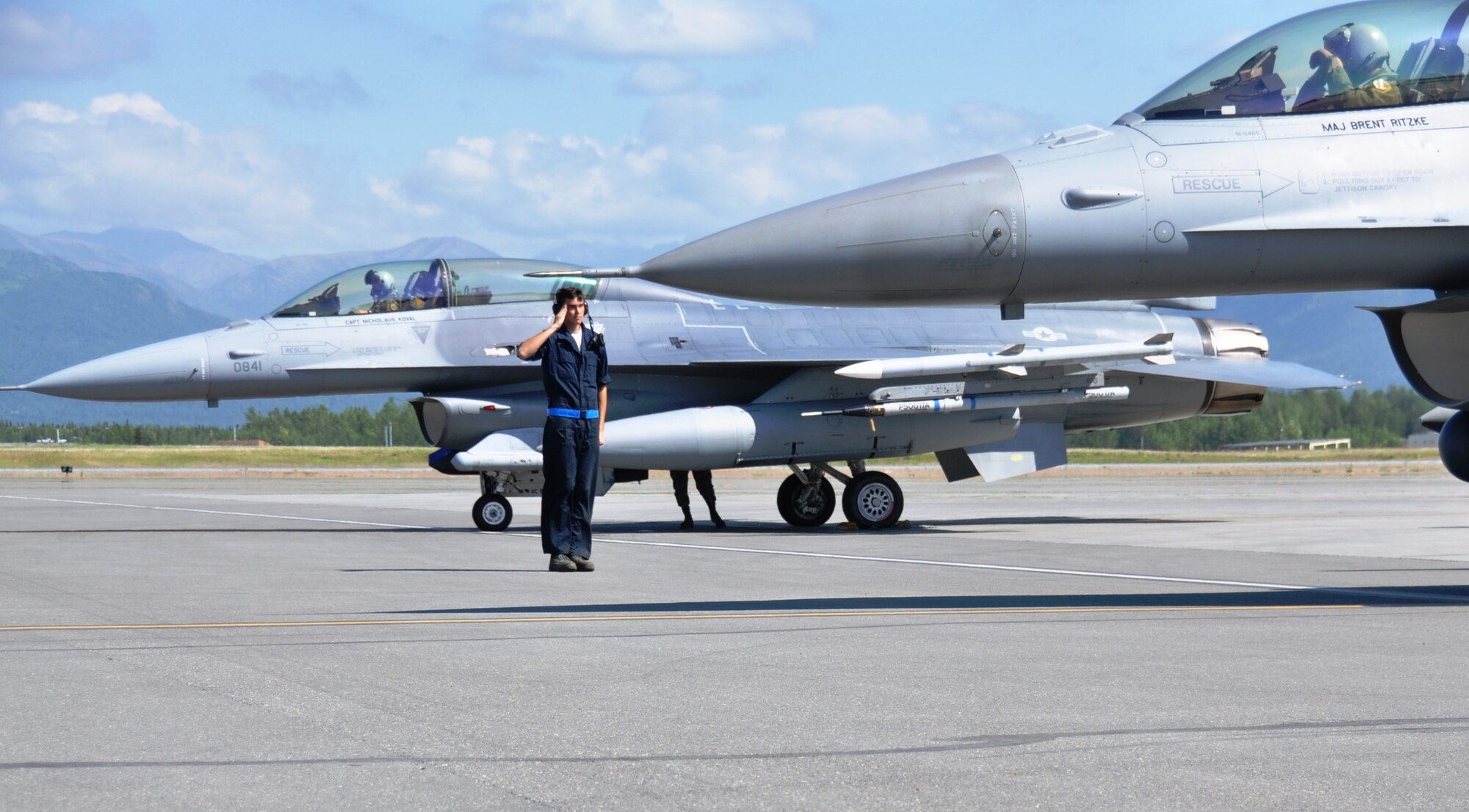 Senior Airman Jeremy Fogle, 96th Aircraft Maintenance Squadron F-16 crew chief from Nazareth, Pa., salutes Maj Grizz Baer, 53rd Wing F-16 pilot from Wolcott, Ind., prior to takeoff for an Exercise Northern Edge mission June 23, 2015.  Northern Edge is Alaska’s premier joint training exercise designed to practice operations, techniques and procedures as well as enhance interoperability among the services. Thousands of service members from active duty, Reserve and National Guard units are involved.  (U.S. Air Force photo/Capt. Tania Bryan)