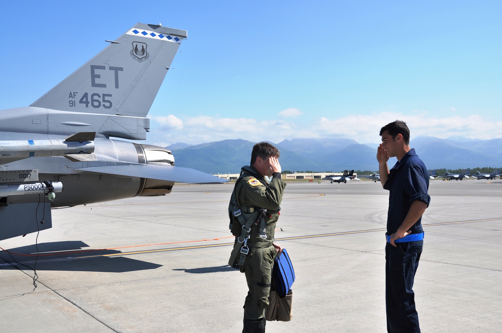 Maj Grizz Baer, 53rd Wing F-16 pilot from Wolcott, Ind., greets Senior Airman Jeremy Fogle, 96th Aircraft Maintenance Squadron F-16 crew chief from Nazareth, Pa. prior to conducting pre-flight checks for an Exercise Northern Edge mission June 23, 2015.  Northern Edge is Alaska’s premier joint training exercise designed to practice operations, techniques and procedures as well as enhance interoperability among the services. Thousands of service members from active duty, Reserve and National Guard units are involved.  (U.S. Air Force photo/Capt. Tania Bryan)