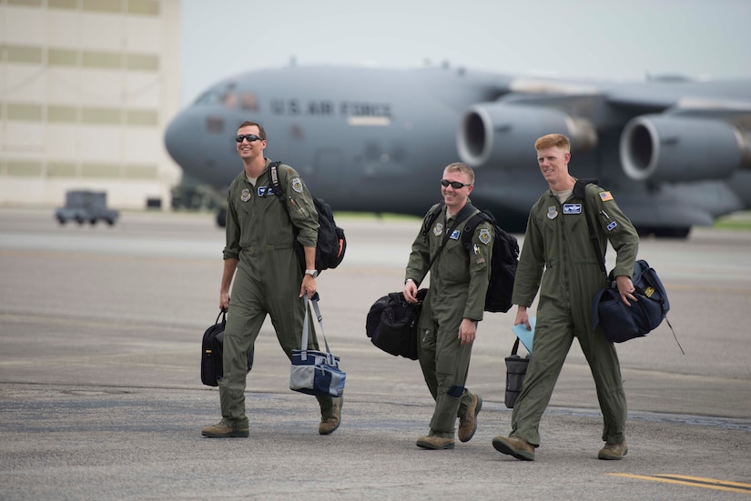 Capt. Ben Wood, Capt. Dan Naske, and Lt. Col. Paul Theriot walk to the hangar for the 17th Airlift Squadron's inactivation ceremony following a squadron C-17 heritage flight June 25, 2015 at Joint Base Charleston, S.C. As part of the President’s Defense Budget for FY15, one of Charleston’s four active-duty C-17 flying squadron inactivated. In attendance at the ceremony were many of the squadron's former commander's including Maj. Gen. (ret) Ron Ladnier. Wood and Naske are pilots with the 17th AS and Theriot is the 17th AS commander.  (U.S. Air Force photo / Trisha Gallaway) 