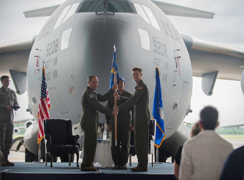 Col. Fred Boehm, 437th Operations Group Commander, accepts the squadron guidon from Lt. Col. Paul Theriot, 17th Airlift Squadron commander, during an inactivation ceremony for the 17th Airlift Squadron, June 25, 2015, at Joint Base Charleston, S.C. As part of the President’s Defense Budget for FY15, one of Charleston’s four active-duty C-17 flying squadron inactivated. The 17th AS was reactivated July 14, 1993 and was the first operational C-17 squadron. (U.S. Air Force photo/Senior Airman Jared Trimarchi) 