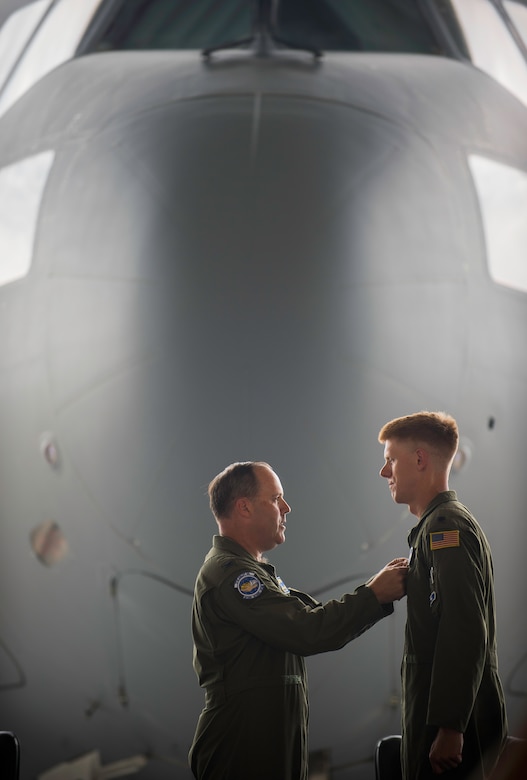 Col. Fred Boehm, 437th Operations Group Commander, pins a Meritorious Service medal onto Lt. Col. Paul Theriot, 17th Airlift Squadron commander, during an inactivation ceremony for the 17th Airlift Squadron, June 25, 2015, at Joint Base Charleston, S.C. As part of the President’s Defense Budget for FY15, one of Charleston’s four active-duty C-17 flying squadron inactivation. The 17th AS was reactivated July 14, 1993 and was the first operational C-17 squadron. (U.S. Air Force photo/Senior Airman Jared Trimarchi) 