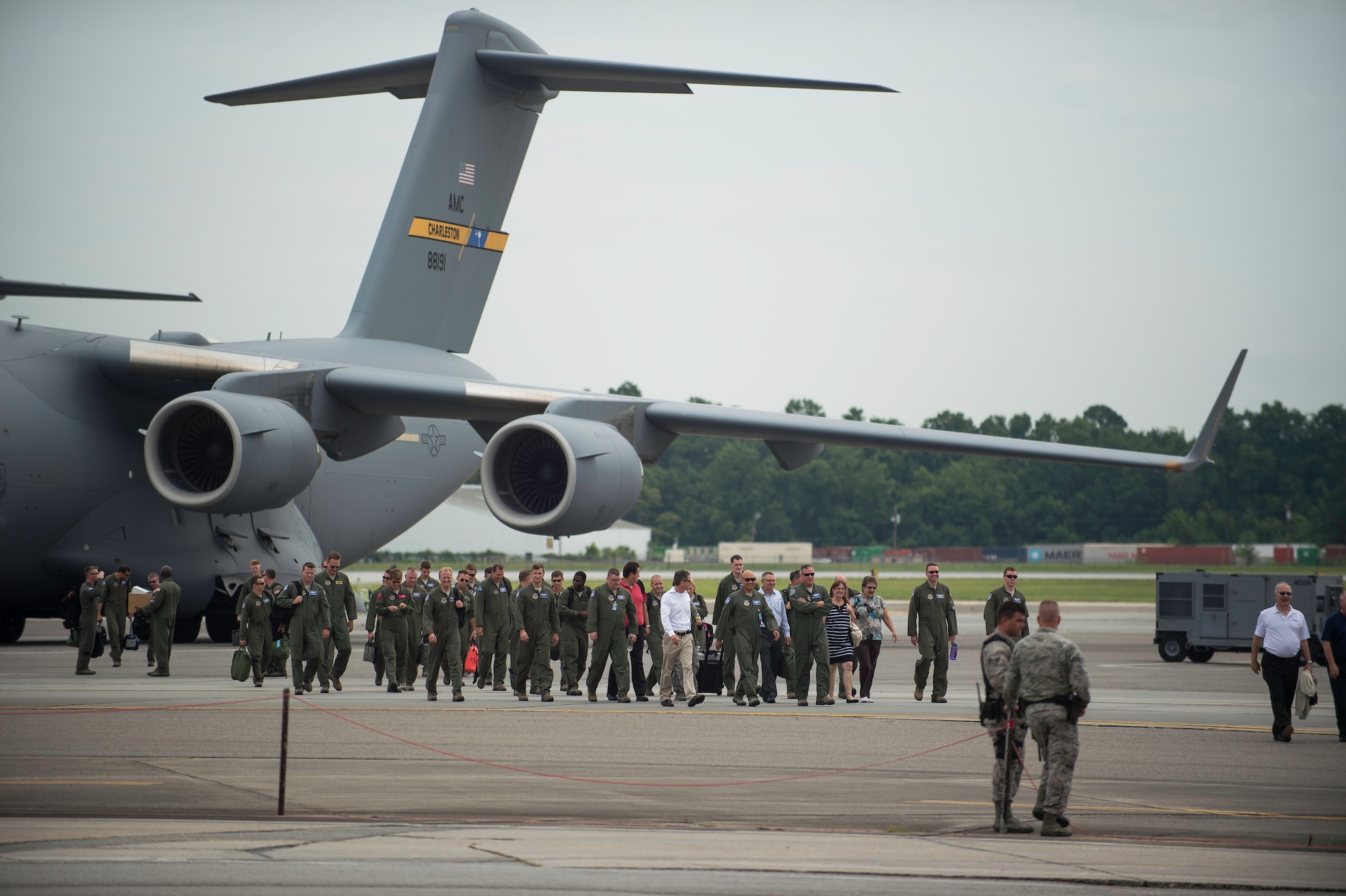 Airmen and distinguished visitors walk off a C-17 Globemaster III after a fini-flight inactivating the 17th Airlift Squadron June 25, 2015, at Joint Base Charleston, S.C. As part of the President’s Defense Budget for FY15, one of Charleston’s four active-duty C-17 flying squadron inactivated. The 17th AS was reactivated July 14, 1993 and was the first operational C-17 squadron. (U.S. Air Force photo/Senior Airman Jared Trimarchi)  
