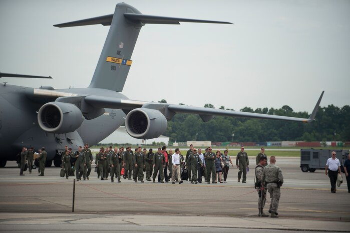 Airmen and distinguished visitors walk off a C-17 Globemaster III after a fini-flight inactivating the 17th Airlift Squadron June 25, 2015, at Joint Base Charleston, S.C. As part of the President’s Defense Budget for FY15, one of Charleston’s four active-duty C-17 flying squadron inactivated. The 17th AS was reactivated July 14, 1993 and was the first operational C-17 squadron. (U.S. Air Force photo/Senior Airman Jared Trimarchi)  
