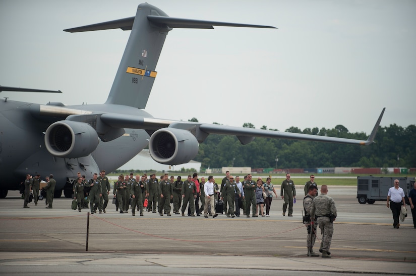 Airmen and distinguished visitors walk off a C-17 Globemaster III after a fini-flight inactivating the 17th Airlift Squadron June 25, 2015, at Joint Base Charleston, S.C. As part of the President’s Defense Budget for FY15, one of Charleston’s four active-duty C-17 flying squadron inactivated. The 17th AS was reactivated July 14, 1993 and was the first operational C-17 squadron. (U.S. Air Force photo/Senior Airman Jared Trimarchi)  
