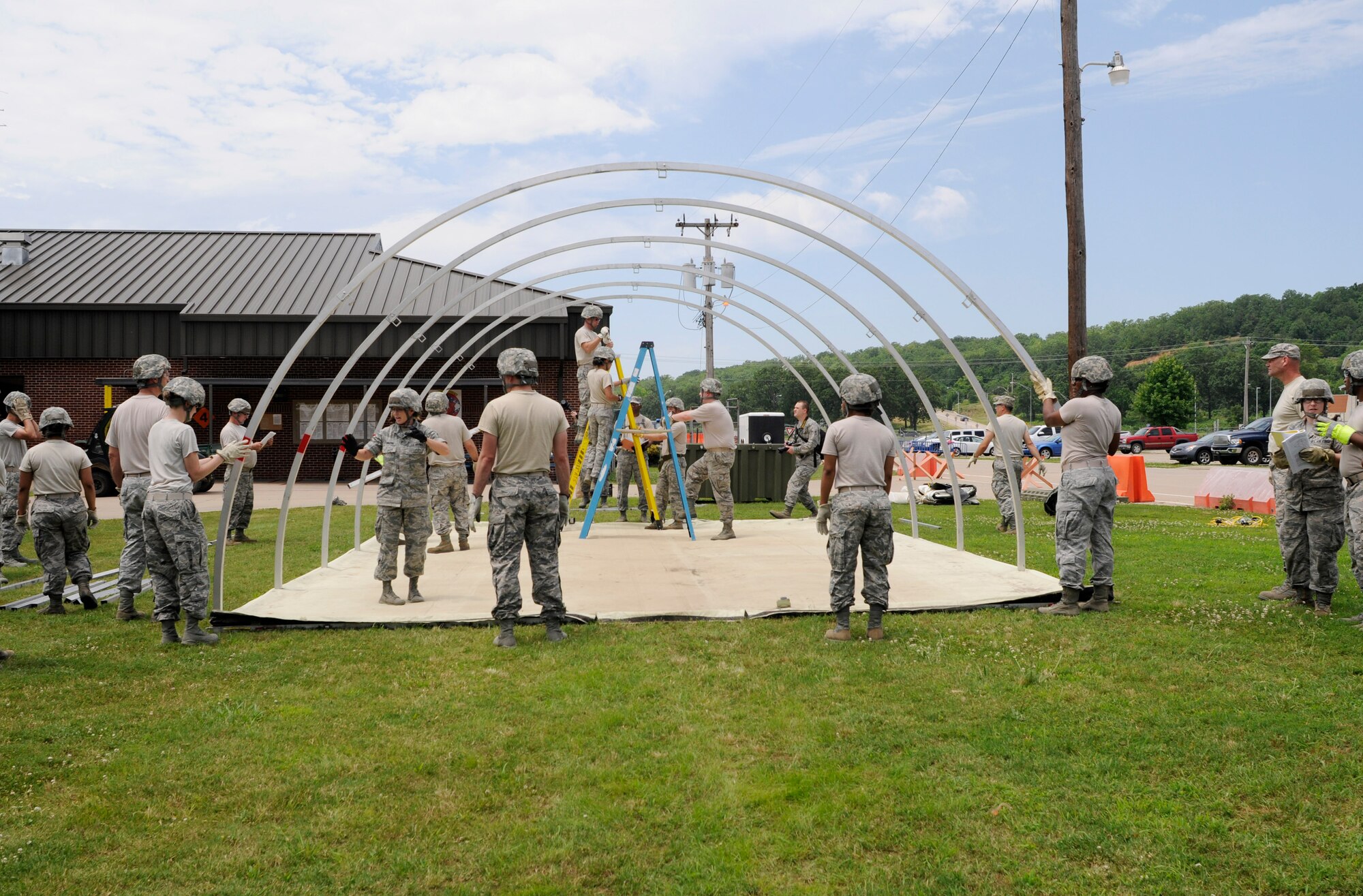 Members of the 188th Force Support Squadron assemble a small shelter system during annual training at Ebbing Air National Guard Base, Ark., June 8, 2015. The SSS provides living quarters for up to 12 personnel in expeditionary environments and requires a minimum of four personnel for set up. Building a SSS is an annual training requirement for FSS Airmen and enhances their skills and knowledge in utilizing the system. (U.S. Air National Guard photo by Staff Sgt. Hannah Dickerson/Released)