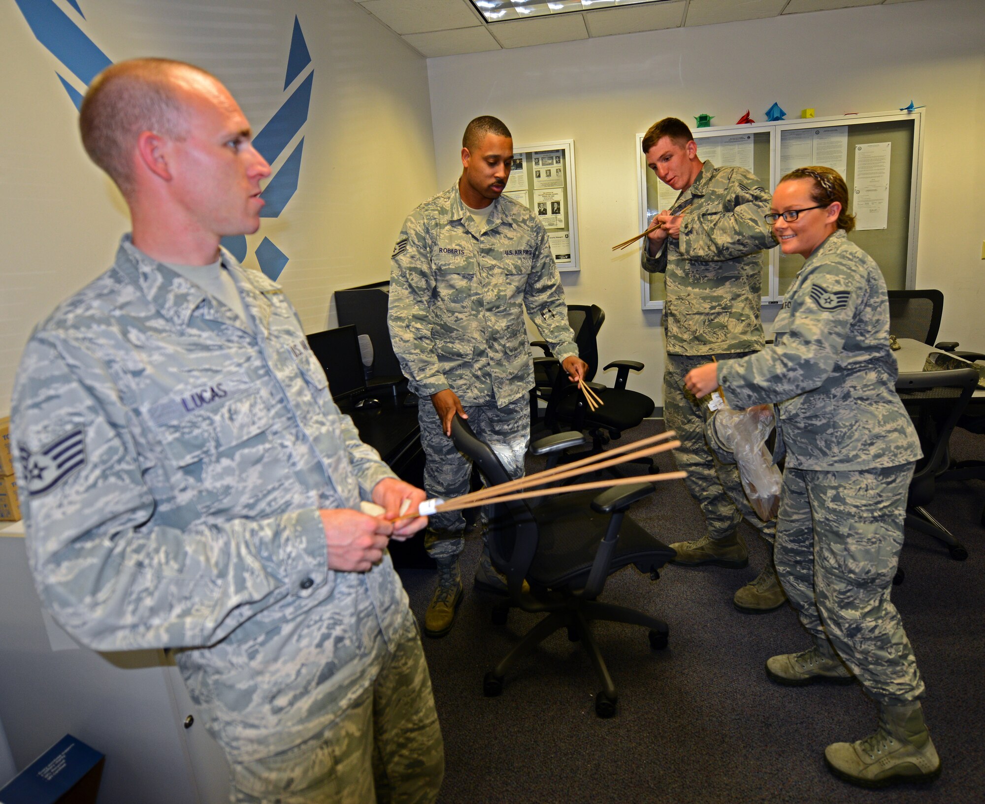 Members of the 22nd Air Refueling Wing safety office hand out punks to McConnell Airmen to promote firework safety, June 25, 2015, at McConnell Air Force Base, Kan. The safety office handed out punks which are the safest way to light fireworks and educated McConnell Airmen to ensure they have the knowledge needed to handle fireworks safely leading up to Independence Day weekend. (U.S. Air Force photo by Airman 1st Class Christopher Thornbury)