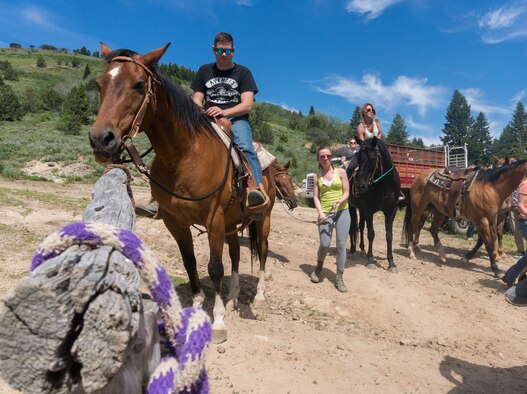 Airmen prepare to dismount their horses after a ride through Silver City, Idaho, June 18, 2015. The Outdoor Recreation Center and Liberty Chapel teamed up to give Airmen and their families the opportunity to increase spiritual resiliency and have fun. (U.S. Air Force photo by Airman 1st Class Connor J. Marth)