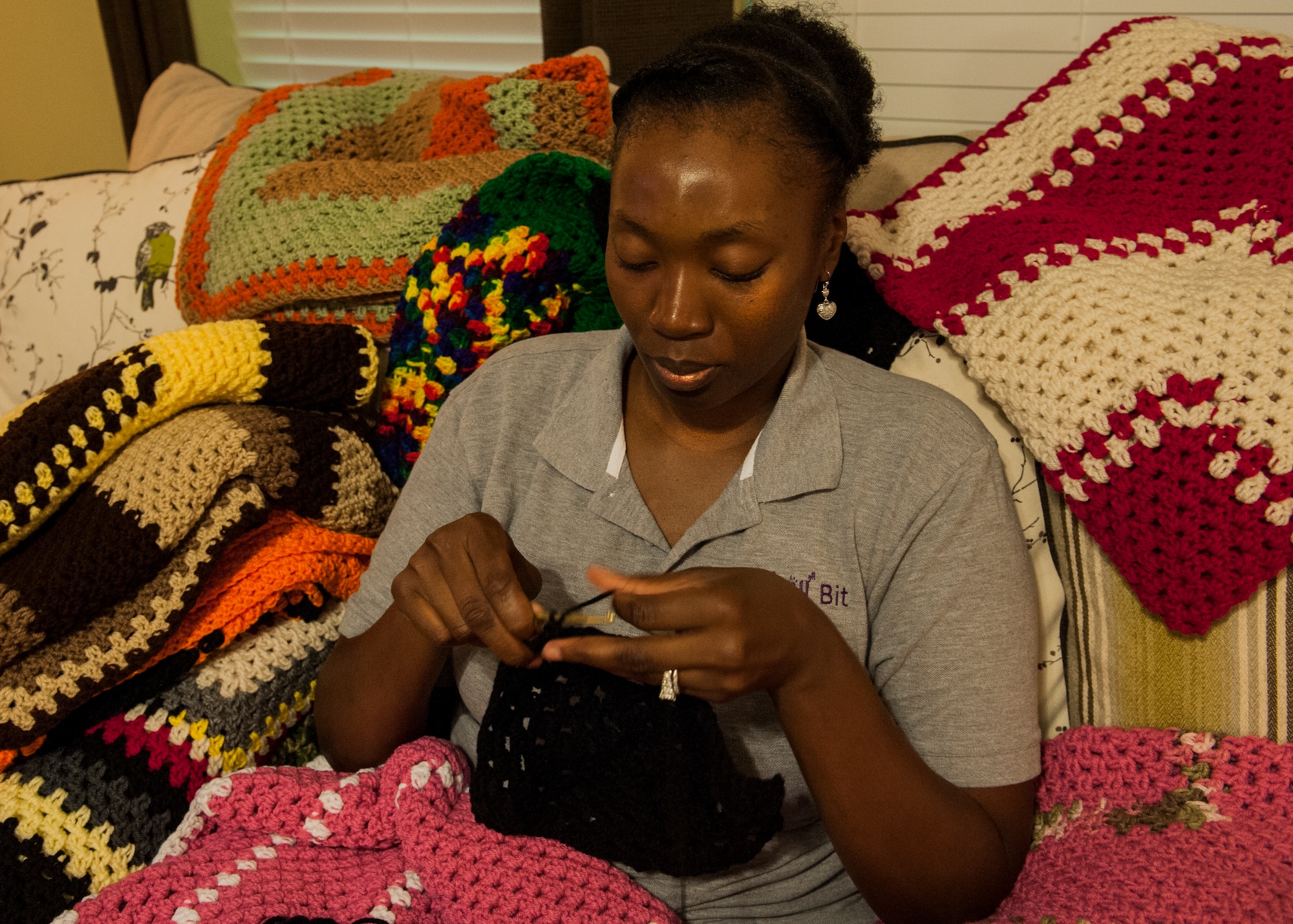 Master Sgt. Candace Ruth, with the 53rd Wing, crochets a blanket June 10 near Eglin Air Force Base, Fla.  Ruth knits to support her husband, Tech. Sgt. Antonio Ruth's, cause.  Ruth, the 33rd Fighter Wing, formed an organization to honor his late mother, and to continue her  legacy of caring and giving.  A “Tiny” Bit of Love provides handmade blankets to cancer patients. (U.S. Air Force photo/Ilka Cole)