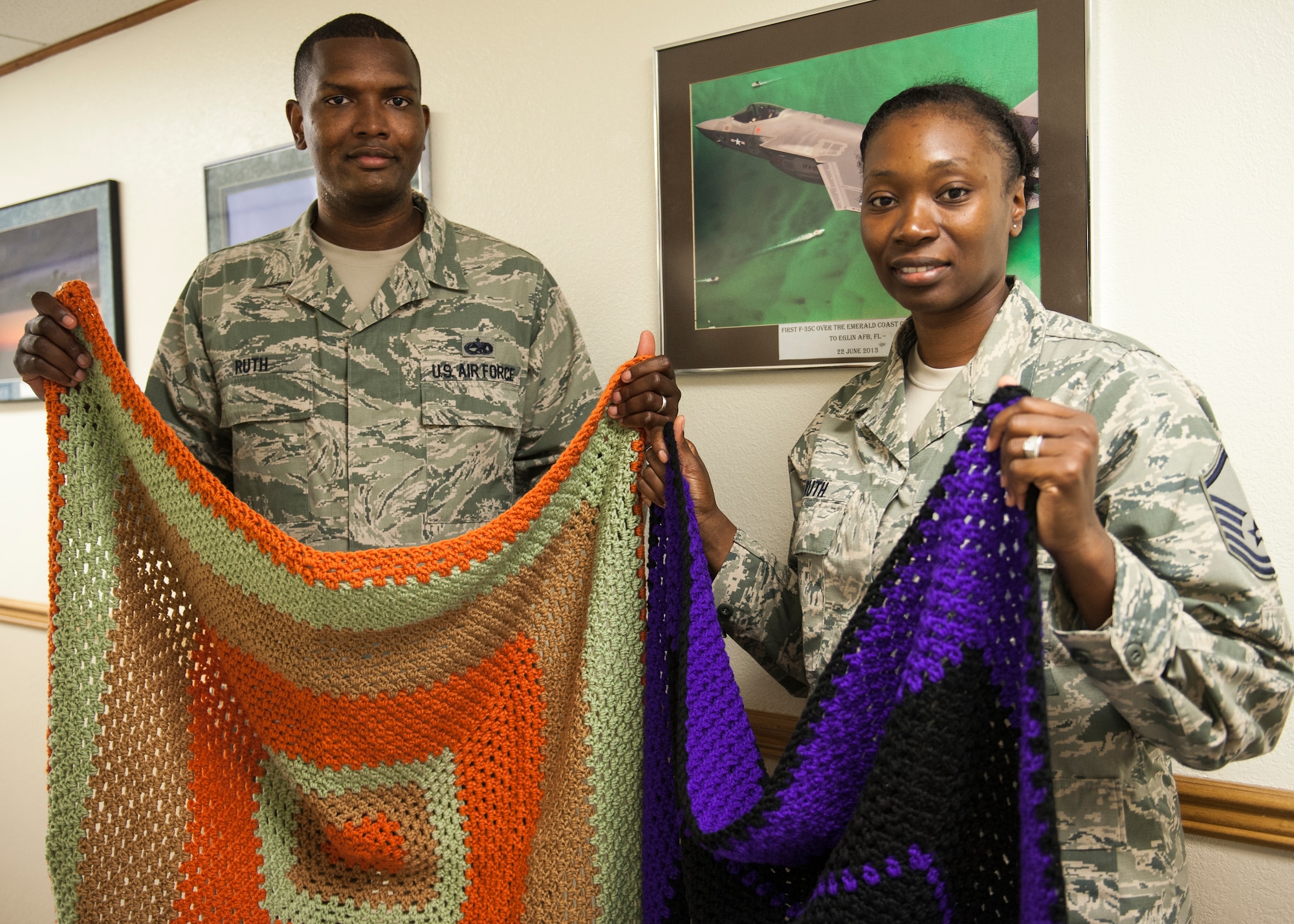 Tech. Sgt. Antonio Ruth, 33rd Fighter Wing and his wife, Master Sgt. Candace Ruth, 53rd Wing, display two blankets crocheted by Master Sgt. Ruth June 16 at Eglin Air Force Base, Fla. Ruth formed an organization to honor his late mother, and to continue her legacy of caring and giving.  A “Tiny” Bit of Love provides handmade blankets to cancer patients. (U.S. Air Force photo/Ilka Cole)