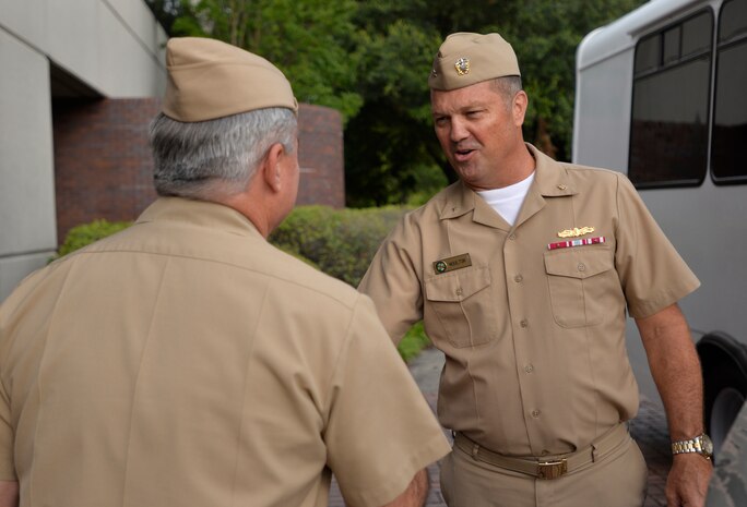 Captain Timothy Sparks (left) greets Rear Admiral Terry Moulton at the Joint Base Charleston headquarters building June 25, 2015 on JB Charleston, S.C. Moulton is in Charleston to preside over the Naval Health Clinic Charleston's change of command ceremony scheduled for June 26, 2015. While visiting Joint Base Charleston, Moulton will also tour NHCC and Naval Nuclear Power Training Command. Sparks is the JB Charleston deputy commander and Moulton is the commander of Navy Medicine East, Portsmouth, Va. (U.S. Air Force photo / Trisha Gallaway) 