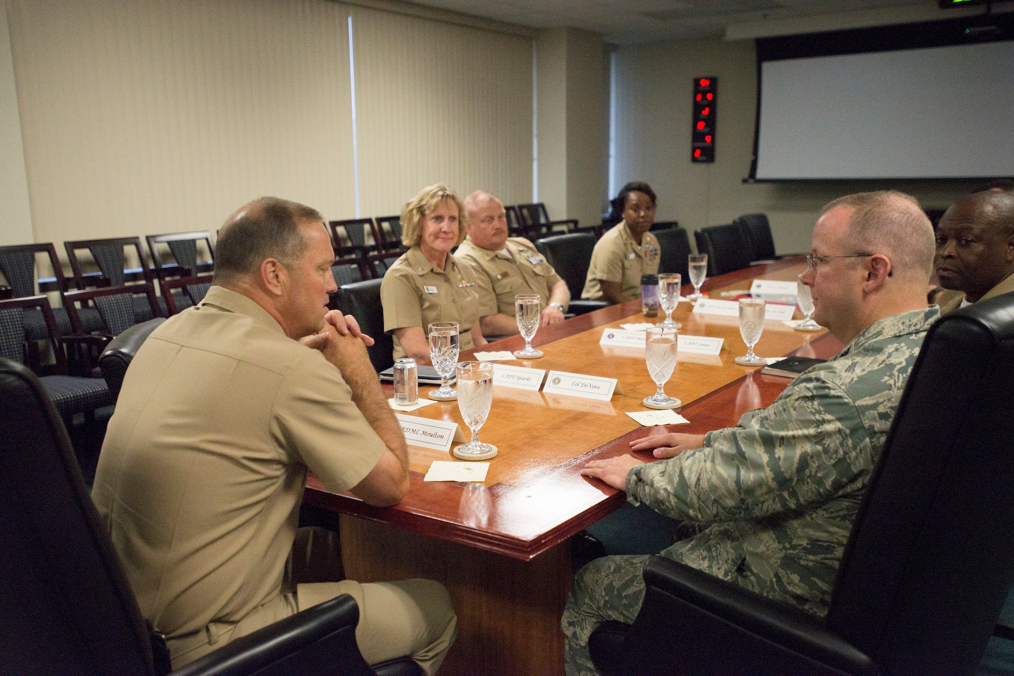 Colonel Jeffrey DeVore (right) briefs Rear Admiral Terry Moulton about the Joint Base Charleston mission June 25, 2015 at JB Charleston, S.C. Moulton is in Charleston to preside over the Naval Health Clinic Charleston's change of command ceremony scheduled for June 26, 2015. While visiting Joint Base Charleston, Moulton will also tour NHCC and Naval Nuclear Power Training Command. DeVore is the JB Charleston command and Moulton is the commander of Navy Medicine East, Portsmouth, Va. (U.S. Air Force photo / Trisha Gallaway) 
