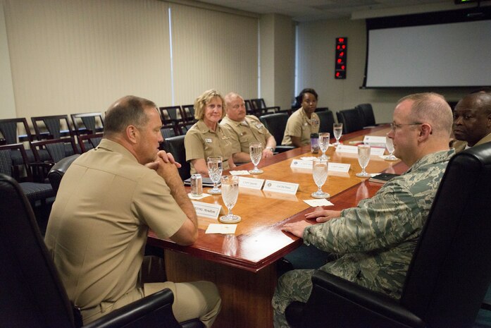 Colonel Jeffrey DeVore (right) briefs Rear Admiral Terry Moulton about the Joint Base Charleston mission June 25, 2015 at JB Charleston, S.C. Moulton is in Charleston to preside over the Naval Health Clinic Charleston's change of command ceremony scheduled for June 26, 2015. While visiting Joint Base Charleston, Moulton will also tour NHCC and Naval Nuclear Power Training Command. DeVore is the JB Charleston command and Moulton is the commander of Navy Medicine East, Portsmouth, Va. (U.S. Air Force photo / Trisha Gallaway) 
