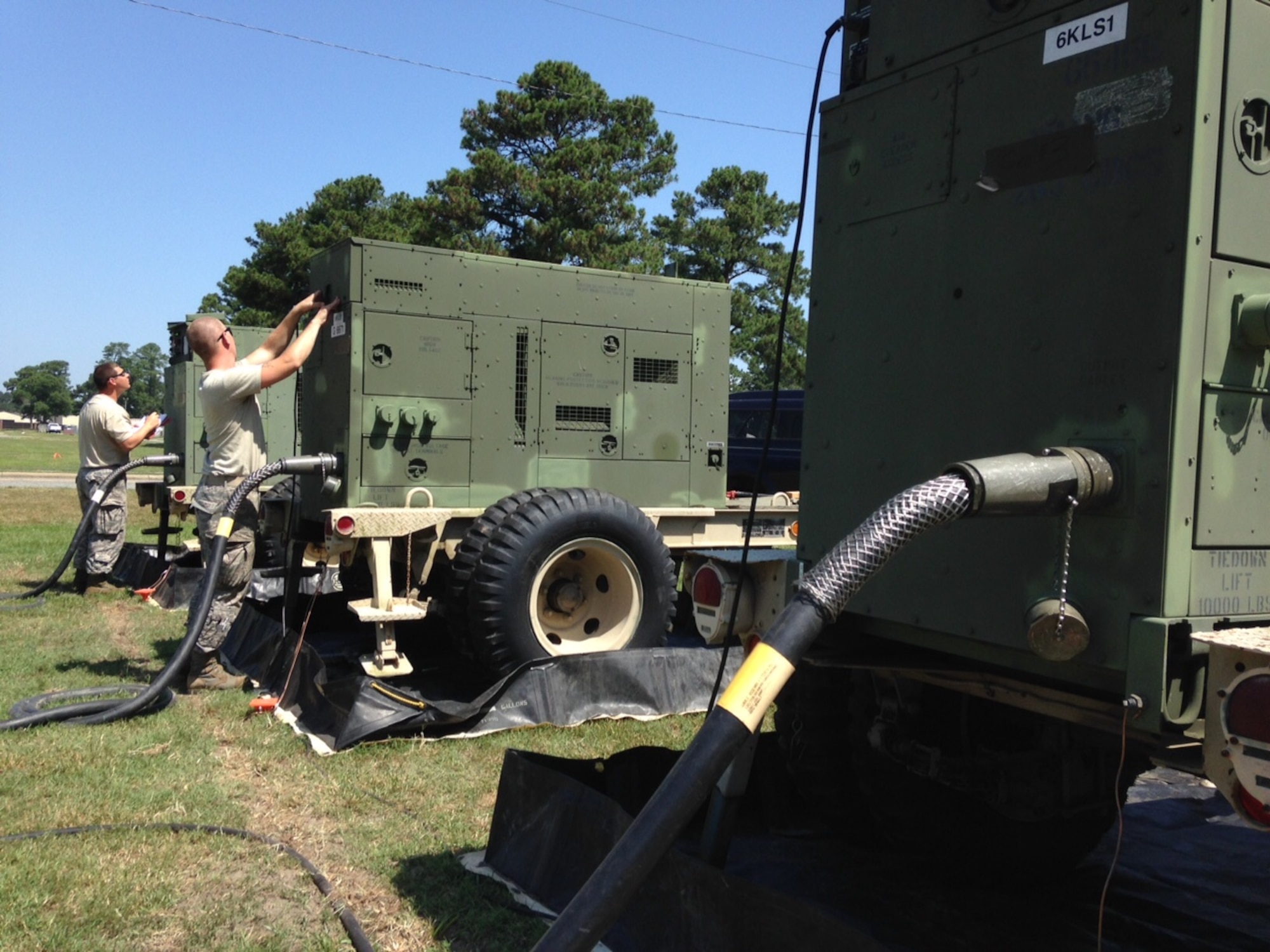 U.S. Air Force Senior Airman Tyler Morton of Mooresville, N.C. and Staff Sgt. Chris Wallace of Greenville, N.C. power production technicians for the 263rd Combat Communications Squadron, New London, N.C. monitor critical systems on a bank of electric generators June 15, 2015 at Seymour Johnson Air Force Base, Goldsboro, N.C. The airmen and their team set up the generators to power the unit's sophisticated communications gear and climate-control equipment during exercise "Medusa Rising," which tested their ability to supply communication services to customers when deployed. (U.S. Air Force photo by Lt. Col. Robert Carver, North Carolina Air National Guard Public Affairs/Released)