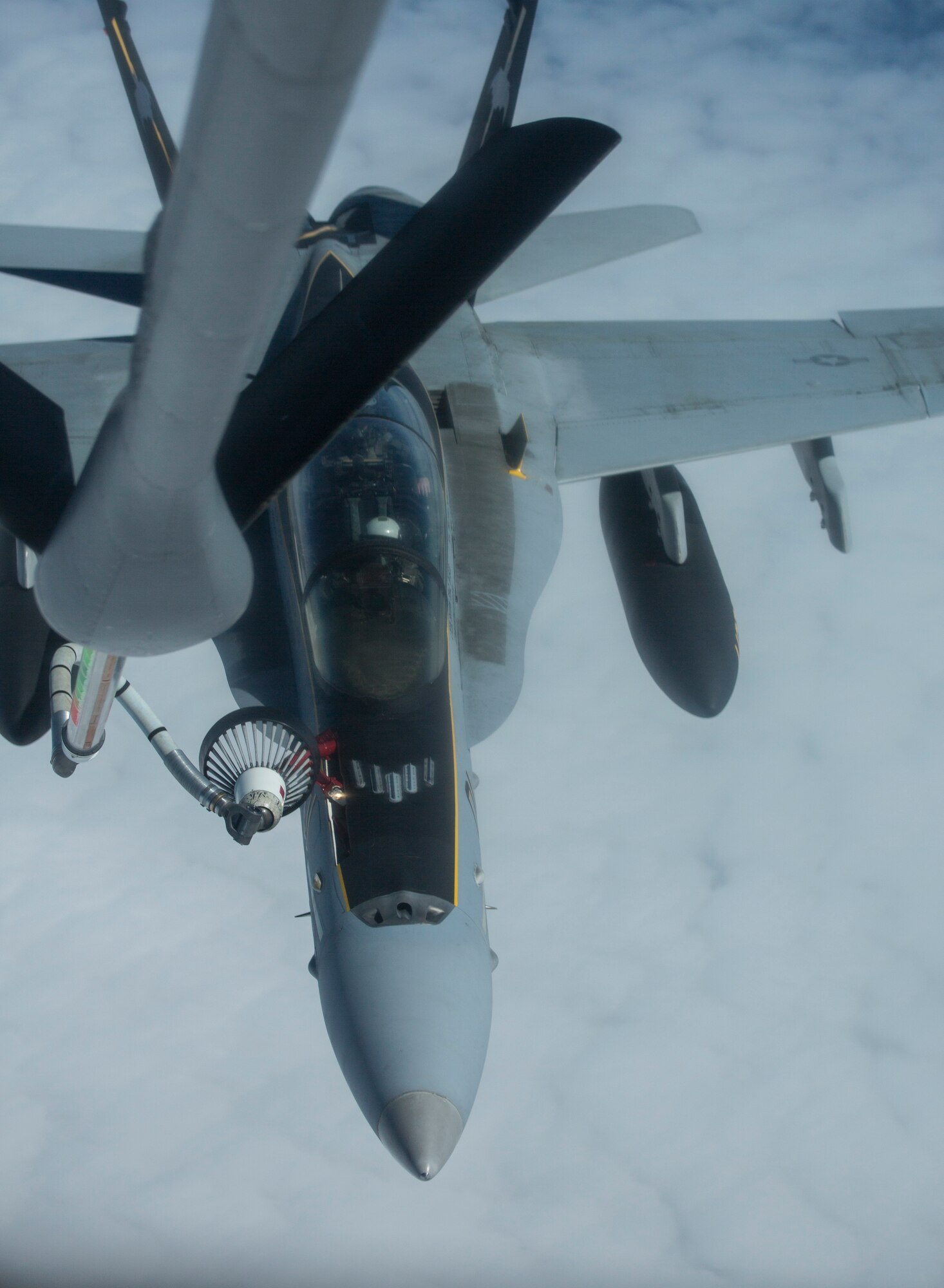 A U.S. Marine Corps F/A-18D Hornet aircraft, assigned to the Marine All-Weather Fighter Attack Squadron 242, 1st Marine Aircraft Wing, attaches to the drogue basket of a U.S. Air Force KC-135R Stratotanker aircraft, assigned to the 459th Air Refueling Wing, Andrews Air Force Base, Md., Air Force Reserve, over the Gulf of Alaska, June 22, 2015. The aircraft was conducting an aerial refuel while flying a training mission during Exercise Northern Edge 15. Northern Edge is Alaska’s premier joint training exercise designed to practice operations, techniques and procedures as well as enhance interoperability among the services. Thousands of Airmen, Soldiers, Sailors, Marines and Coast Guardsmen from active duty, reserve and National Guard units are involved. (U.S. Marine Corps photo by Staff Sgt. Jeffrey D. Anderson/ Released)