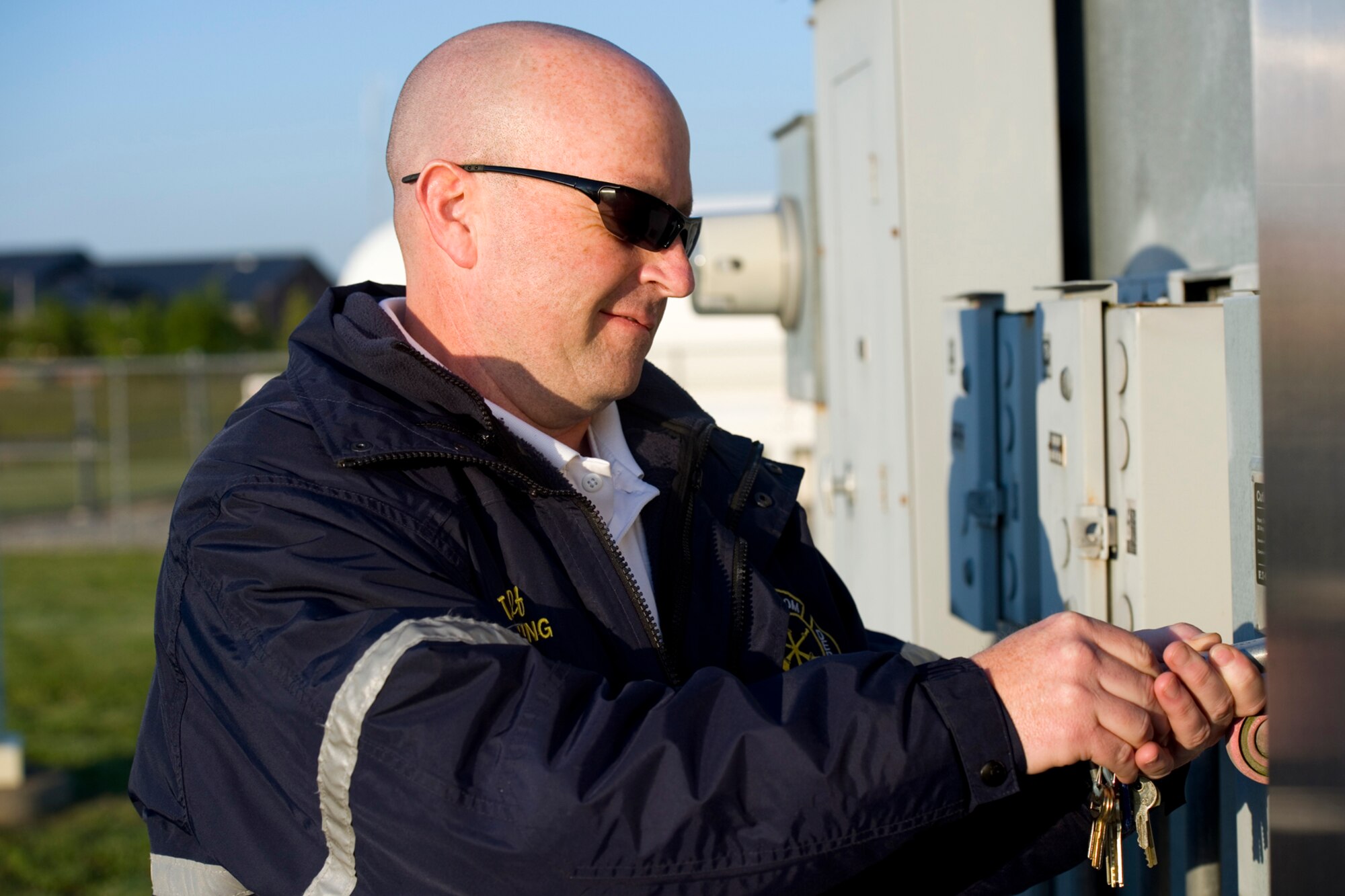 Todd Woolf, Grissom Fire Department assistant chief of training, unlocks an electric control box to send power to Grissom's fire pit control tower at Grissom Air Reserve Base, Ind., May 21, 2015. Grissom's fire pit uses a mock aircraft to familiarize firefighters with techniques used to exterminate an aircraft fire and extract passengers. (U.S. Air Force photo/Tech. Sgt. Benjamin Mota)