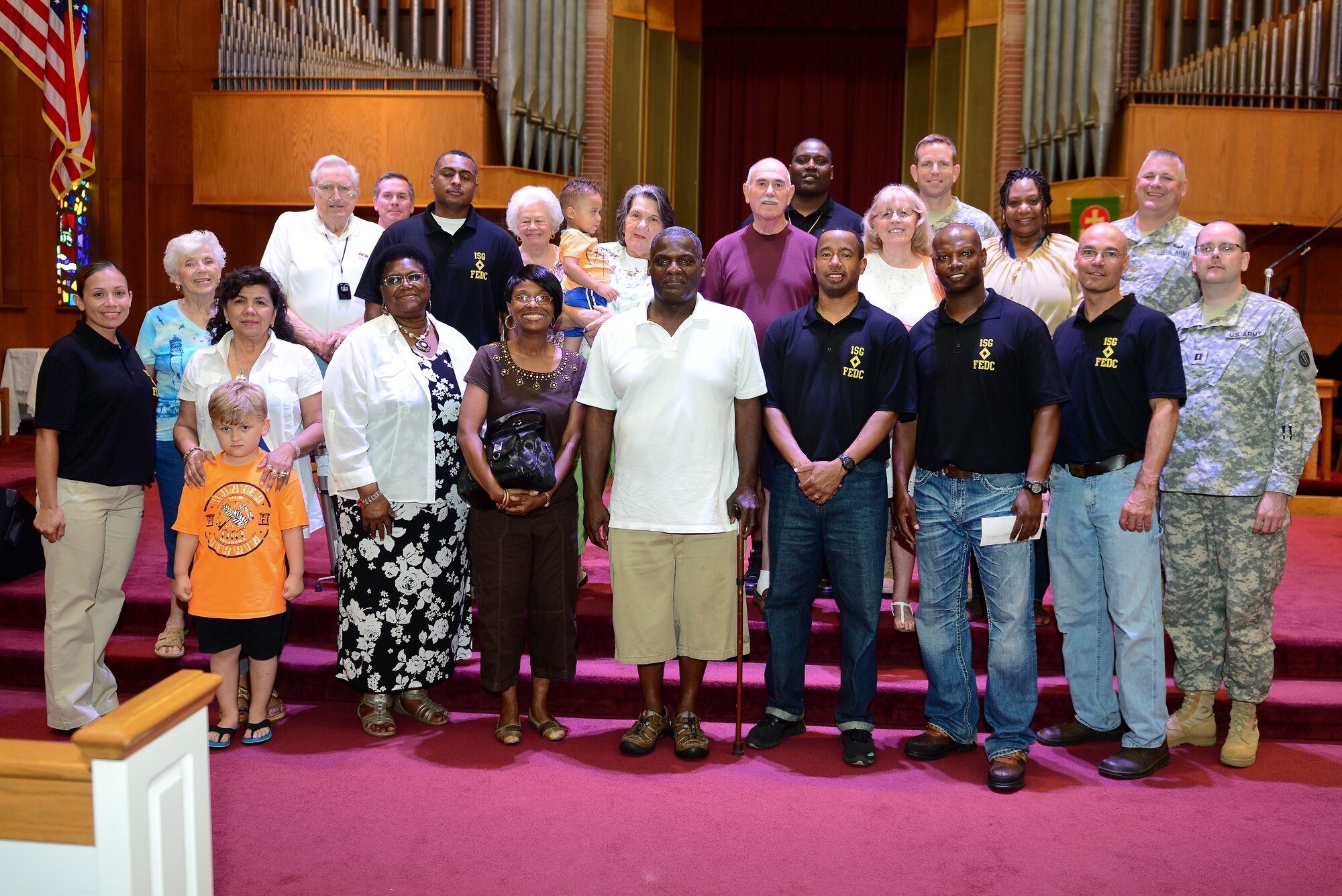 Members of the Fort Eustis Diamond Council pose with members of different Regiment Chapel congregations at Fort Eustis, Va., June 23, 2015. The chapel donated to the FEDC from their offerings to help the council assist post Soldiers. (U.S. Air Force photo by Senior Airman Kimberly Nagle/Released)