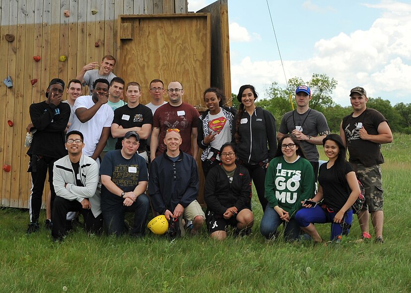 Grand Forks Air Force Base Airmen stop to pose for a group photo at the end of a resiliency day provided by the Grand Forks AFB chapel team at Park River Bible Camp, Park River, N.D., June 22, 2015. The Airmen were able to take a day off from regular duties to foster friendships and build teamwork by participating in a high ropes course and a climbing tower. (U.S. Air Force photo by Airman 1st Class Bonnie Grantham/Released)