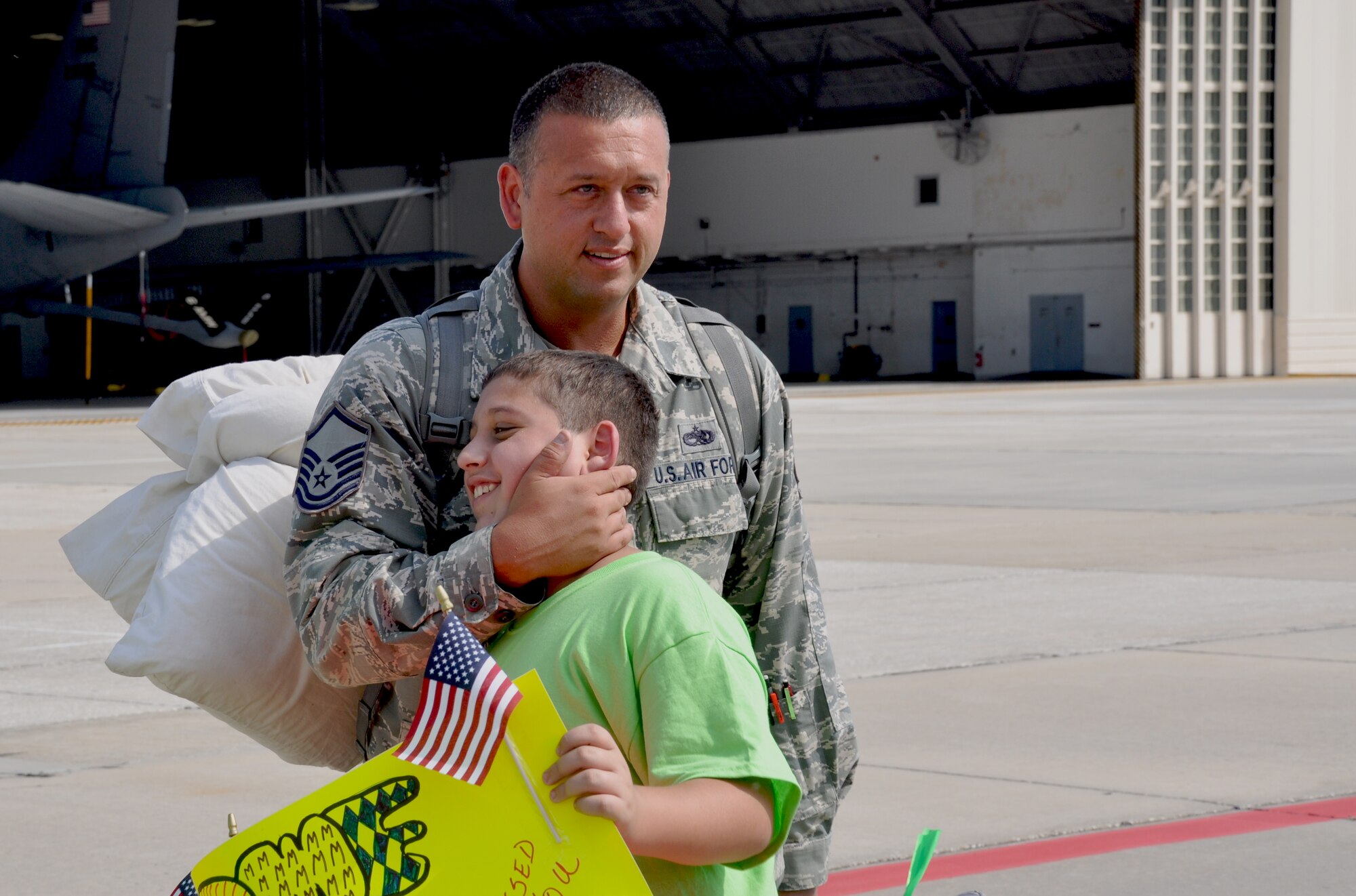 Master Sgt. Phil Giacalone hugs his son after returning from an extended deployment June 17, 2015 at MacDill Air Force Base. Members of the 927th Air Refueling Wing deployed to southwest Asia in support of Operation Inherent Resolve. The 927 ARW’s mission is to support the totally integrated mission by extending global reach while providing global air refueling and airlift operations. (U.S. Air Force photo by Staff Sgt. Adam C. Borgman)