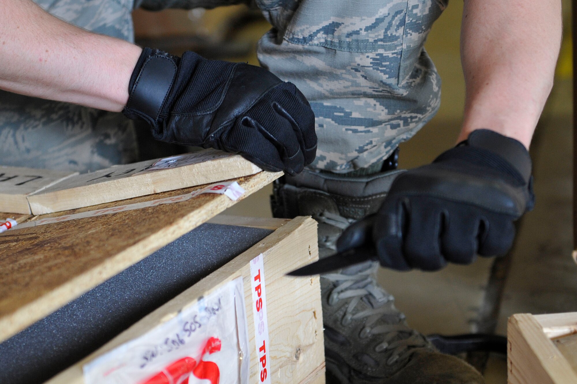 U.S. Air Force Airman 1st Class Tyler Stork, 633rd Logistics Readiness Squadron Traffic Management Operations inbound and receiving technician, opens a crate at Langley Air Force Base, Va., June 24, 2015. Stork “in-checks” numerous boxes every day for delivery to units across the instillation.  (U.S. Air Force photo by Senior Airman Breonna Veal)  