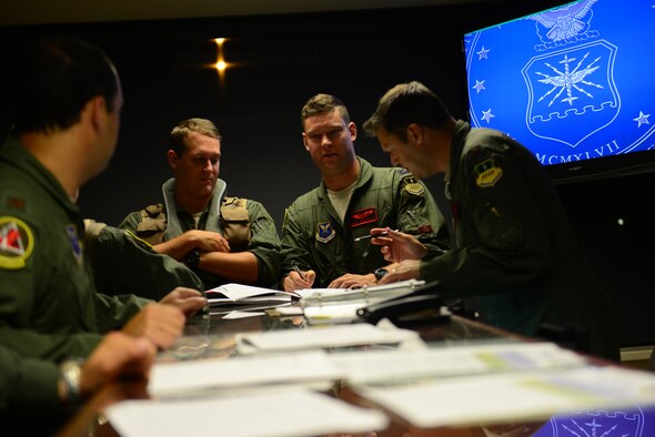 Aircrew from the 96th Bomb Squadron have a discussion after a pre-departure briefing for Exercise Northern Edge 2015 on Barksdale air Force Base, La., June 22, 2015. Northern Edge is a joint training exercise involving all military branches and prepares joint forces to respond to crises in the Indo-Asia-Pacific region. (U.S. Air Force photo/Airman 1st Class Luke Hill)