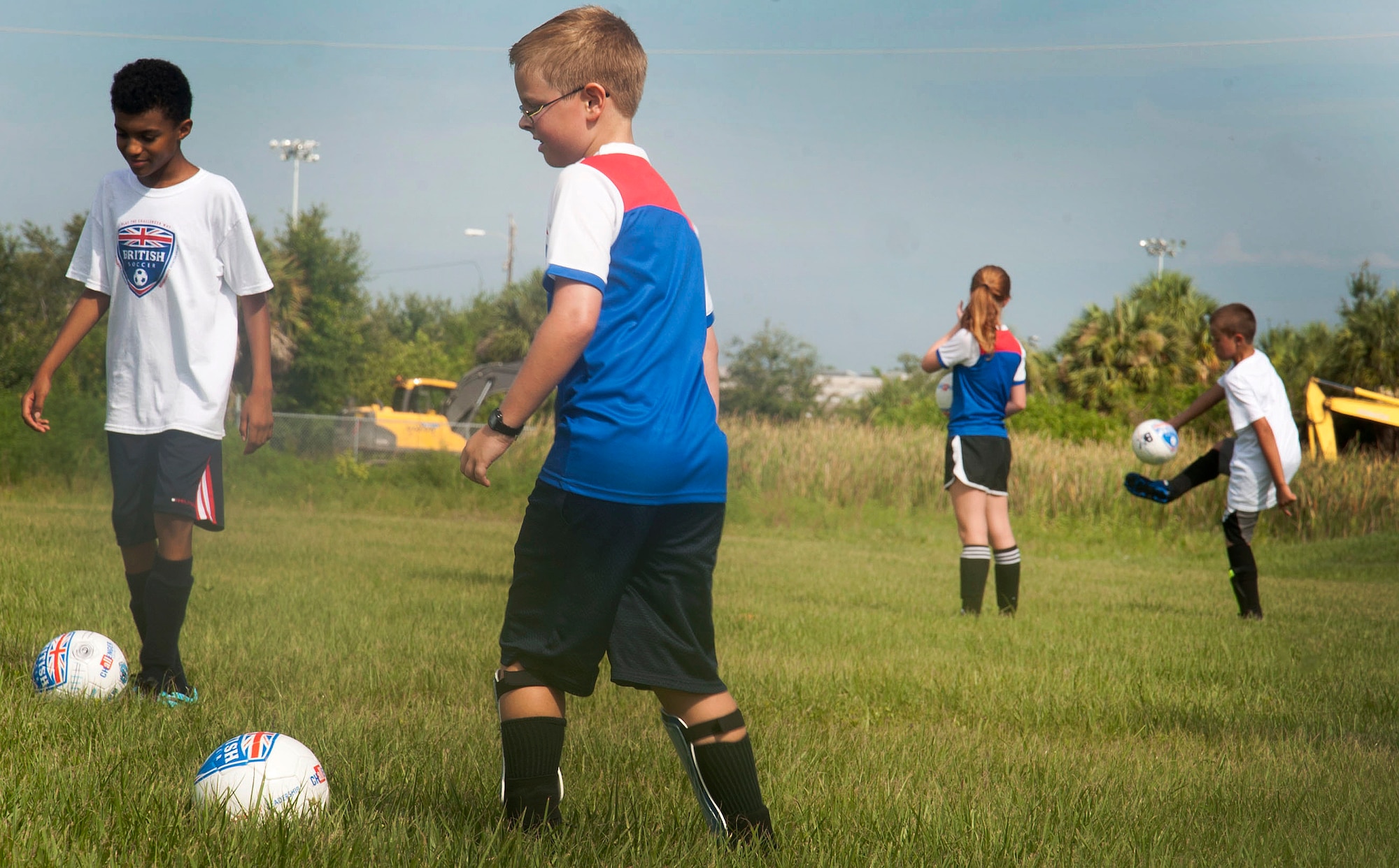 Children from the Youth Center Program participate in the British Soccer Summer Camp June 23, 2015, at MacDill Air Force Base, Fla. This week-long camp is one of the most popular sport summer camps in the country.  (U.S. Air Force photo by Senior Airman Jenay Randolph/Released)