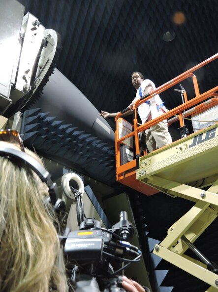 Working inside of a specially designed test range, Clarence Thrower, 566th Electronics Maintenance Squadron electronics technician, takes readings and marks each nose cone with the exact location to apply the radar signal corrective tape. The 566th EMXS F-15 Radome Shop will be featured on 13WMAZ's "Behind the Lines" segment airing on the June 25 Eyewitness News telecast at 6 p.m. 
(U.S. Air Force photo by Roland Leach)

