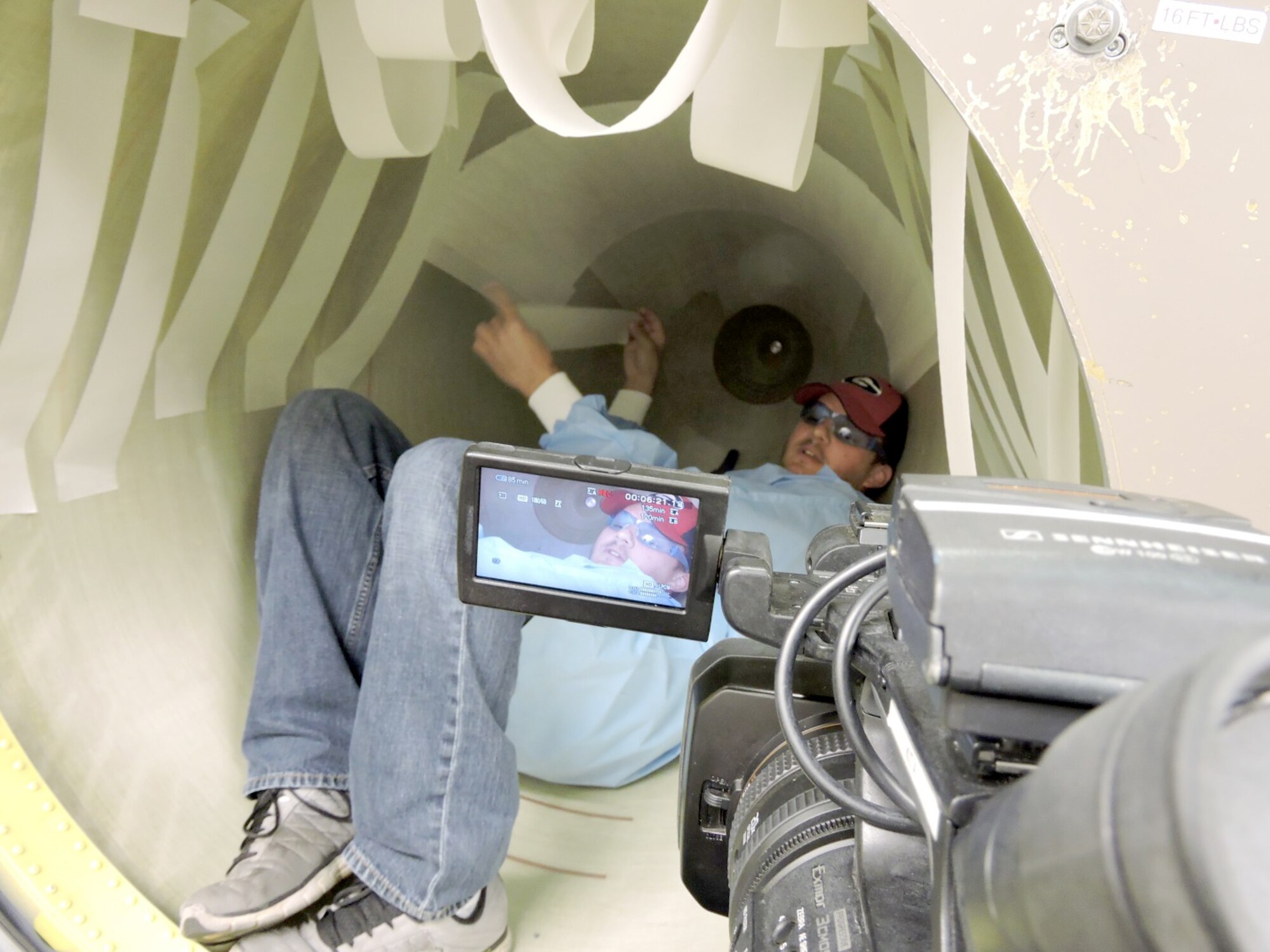 William Coleman, 566th Electronics Maintenance Squadron electronics technician, applies fiberglass tape inside an F-15 nose cone to allow the aircraft’s radar system to “see clearly” the view ahead. The 566th EMXS F-15 Radome Shop will be featured on 13WMAZ's "Behind the Lines" segment airing on the June 25th Eyewitness News telecast at 6 p.m. (U.S. Air Force photo by Roland Leach)

