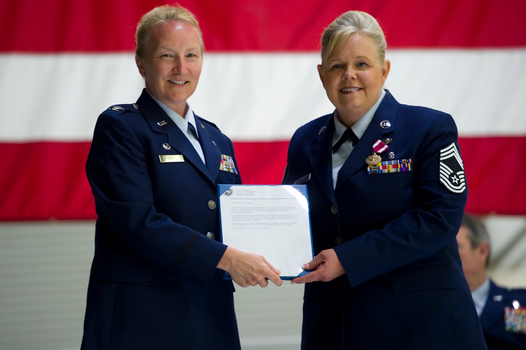 Chief Master Louise Dietzer-Hensley, 434th Aerospace Medicine Squadron Wing senior enlisted advisor, poses for a photo after receiving her certificate of retirement from Col. Therese Kern, 434th Aerospace Medicine Squadron commander, during her retirement ceremony at Grissom Air Reserve Base, Ind., June 7. (U.S. Air Force photo/Senior Airman Jami K. Lancette)
