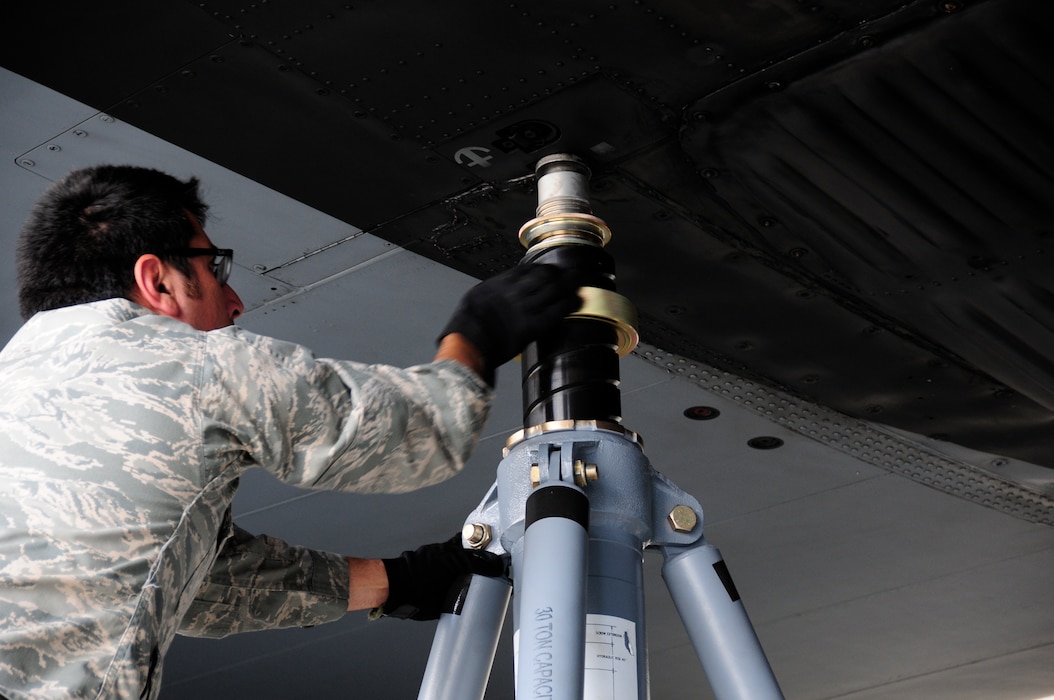 U.S. Air Force Staff Sgt. Alejandro Armendariz, 145th Maintenance Squadron, seats a jack to the wing of a C-130 Hercules aircraft while other maintainers position new Isochronal Inspection (ISO) Aircraft Maintenance Platforms around the aircraft at the North Carolina Air National Guard base, Charlotte Douglas International Airport, June 2, 2015. (U.S. Air National Guard photo by Master Sgt. Patricia F. Moran, 145th Public Affairs/Released)