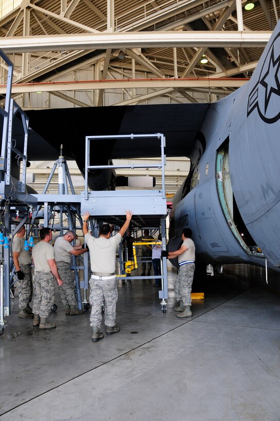 145th Airlift Wing maintainer’s position sections of the new Isochronal Inspection (ISO) Aircraft Maintenance stand around a C-130 Hercules aircraft inside the maintenance hangar at the North Carolina Air National Guard base, Charlotte Douglas International Airport, June 2, 2015. These new stands, which provide maintainers quicker and safer access to all areas of the C-130, are part of an Air Force-wide mission to replace aircraft maintenance platforms for all C-130 aircraft.  (U.S. Air National Guard photo by Master Sgt. Patricia F. Moran, 145th Public Affairs/Released)