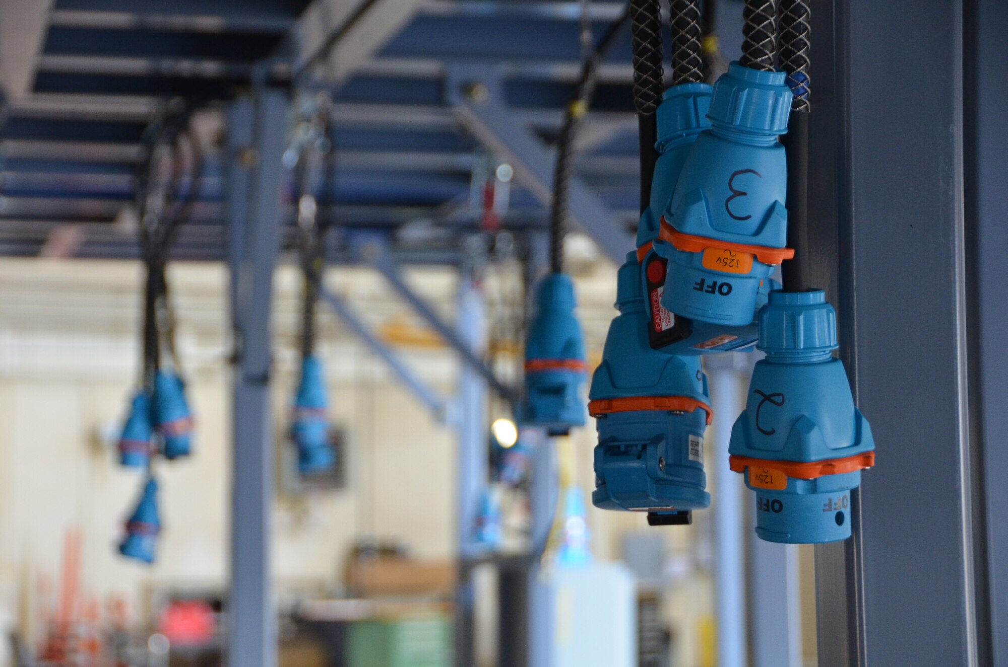 Electrical plugs hang ready to install to provide power to the Isochronal Inspection (ISO) Aircraft Maintenance Platforms that are prepositioned in the C-130 maintenance hangar at the North Carolina Air National Guard Base, Charlotte Douglas International Airport; May 30, 2015. The new ISO stands provide 145th Airlift Wing maintainers quicker and safer access to all areas of the C-130 aircraft compared to the old stand system. (U.S. Air National Guard photo by Master Sgt. Patricia F. Moran, 145th Public Affairs/Released)