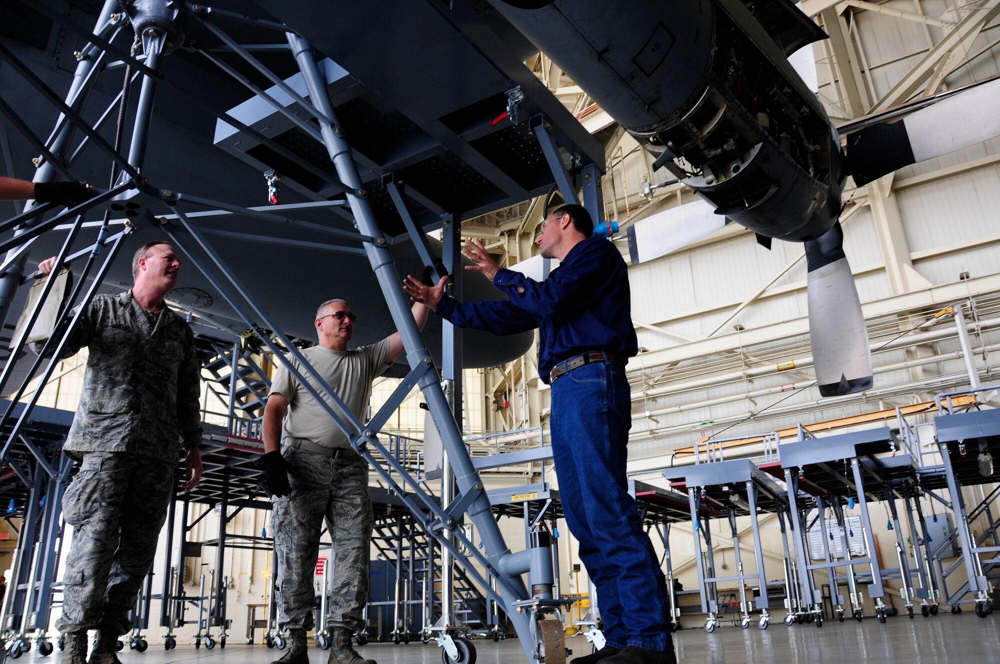 U.S. Air Force Senior Master Sgt. Christopher Mueller, 145th Maintenance Squadron (MXS) Aircraft Inspection Superintendent, Master Sgt. Kevin Mignosa, 145th MXS, ISO Dock leader and a representative from Flexible Lifeline Systems, discuss the placement of a wing jack stand during installation of new Isochronal Inspection (ISO) Aircraft Maintenance Platforms at the North Carolina Air National Guard base, Charlotte Douglas International Airport, June 2, 2015. (U.S. Air National Guard photo by Master Sgt. Patricia F. Moran, 145th Public Affairs/Released)