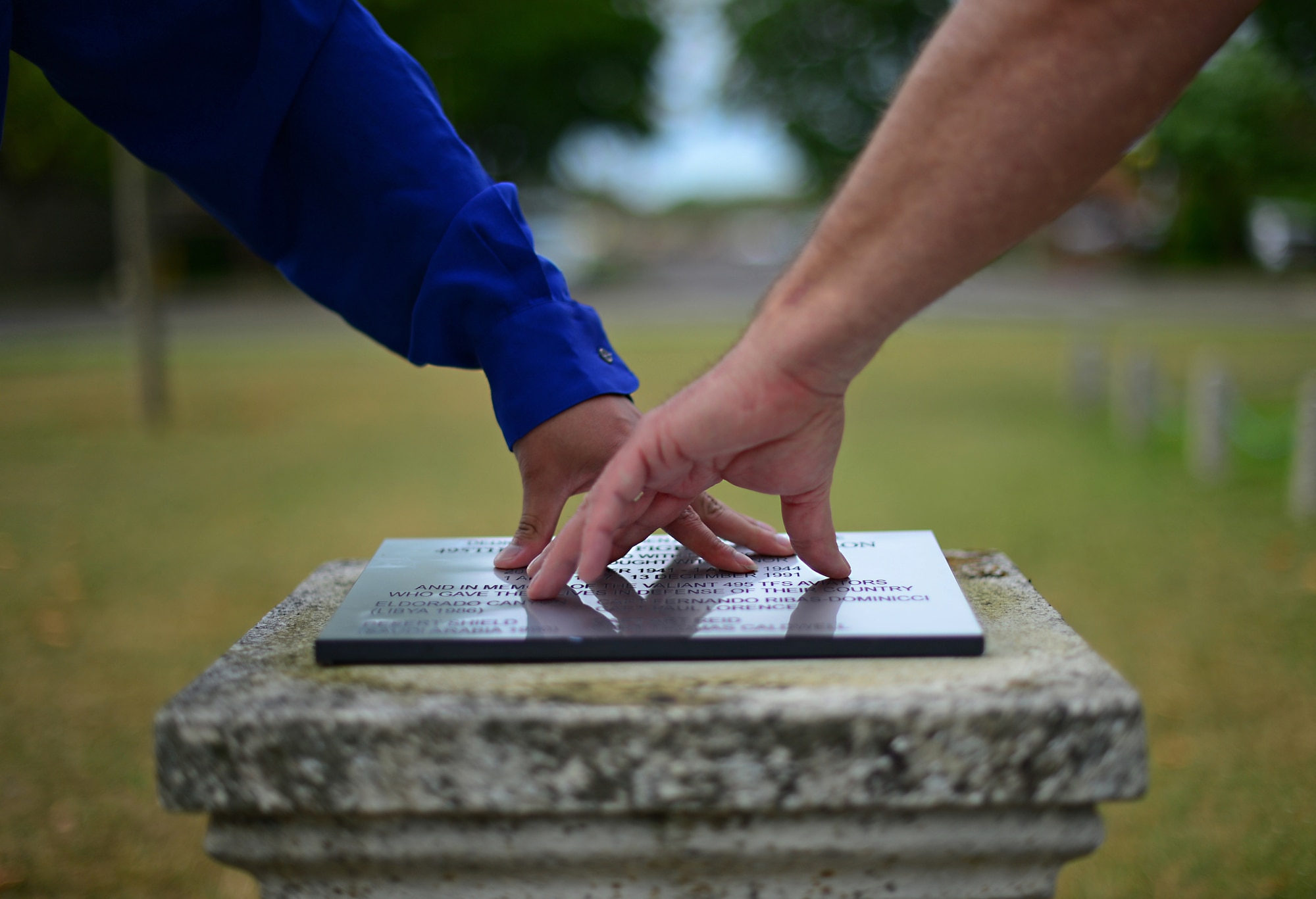 Josh Kelley, a former Air Force Junior ROTC member, and his Father, Terry, apply pressure to a newly placed memorial plaque dedicated to the 495th Tactical Fighter Squadron, a deactivated fighter squadron, at Royal Air Force Lakenheath, England, June 19, 2015. Activated in 1977, the squadron functioned as a replacement training unit for the Liberty Wing’s 492nd, 493rd and 494th Fighter Squadrons that are active today. (U.S. Air Force photo by Senior Airman Erin O’Shea/Released)