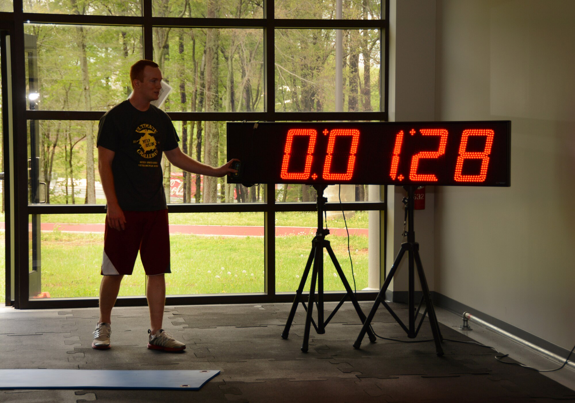 U. S. Air Force Senior Airman Cody Hilton, Fitness Specialist for 145th Force Support Squadron, starts the clock for airmen participating in an exercise program called “Beat the PT” at the North Carolina Air National Guard base, Charlotte Douglas International Airport, April 14, 2015. Beat the PT is a six week fitness program created by Hilton, which supplies all of the tools and advice necessary for every fitness level to members wishing to improve scores on the Air Force Fitness Assessment. The program includes strength and endurance exercises in a short 25 minutes or less conducted in a timely circuit training fashion. (U.S. Air National Guard photo by Master Sgt. Patricia F. Moran, 145th Public Affairs/Released) 