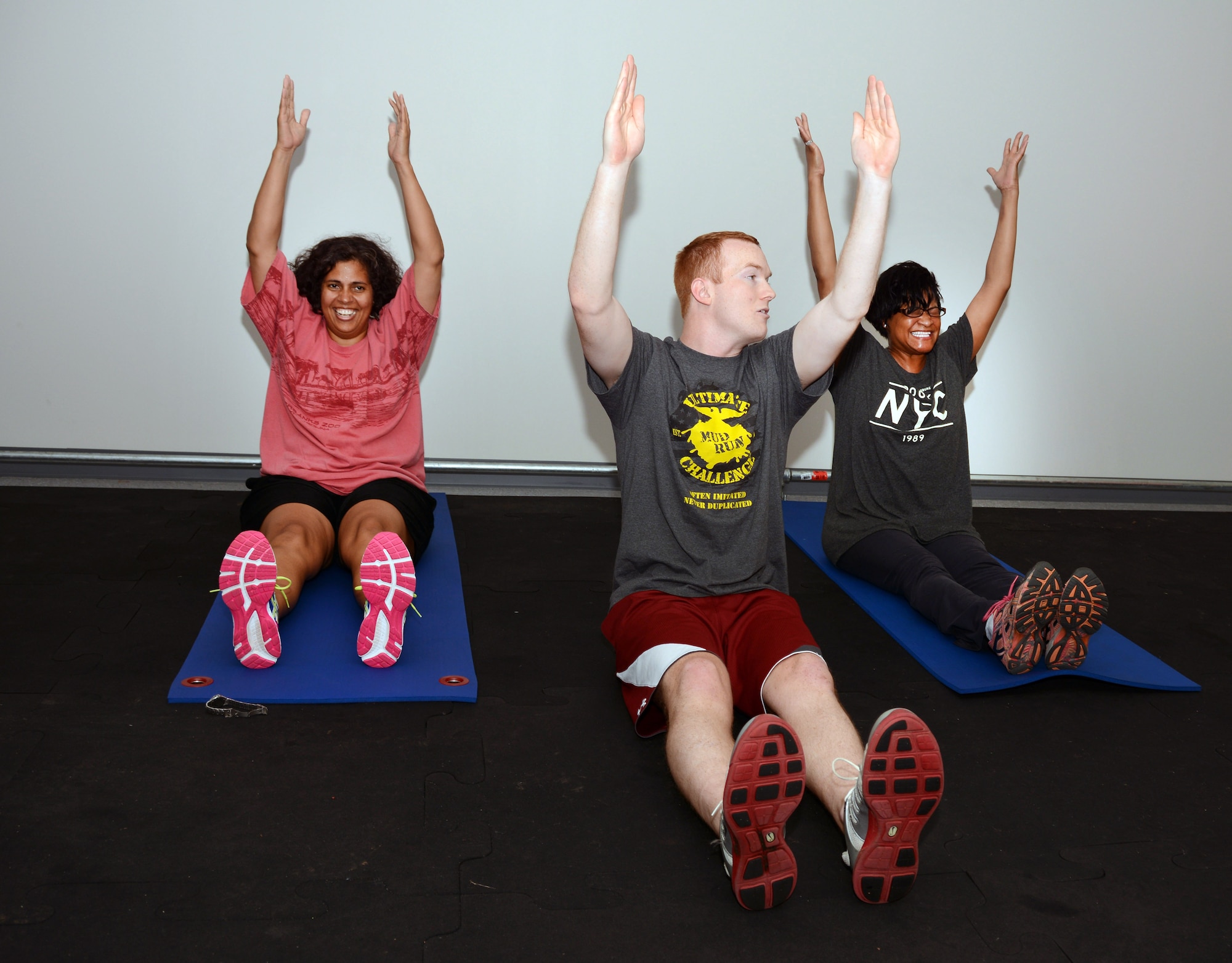 U. S. Air Force Senior Airman Cody Hilton, Fitness Specialist for 145th Force Support Squadron, coaches Capt. Tammy Terry, Medical Administrative Officer and Tech. Sgt. Traci Morse, a Health Systems Technician, both members of the145th Medical Group, through a fitness program called Beat the PT at the North Carolina Air National Guard base, Charlotte Douglas International Airport, April 14, 2015. Beat the PT is a six week fitness program created by Hilton, which supplies all of the tools and advice necessary in every fitness level to members wishing to improve scores on the Air Force Fitness Assessment and achieve their fitness goals. (U.S. Air National Guard photo by Master Sgt. Patricia F. Moran, 145th Public Affairs/Released)
