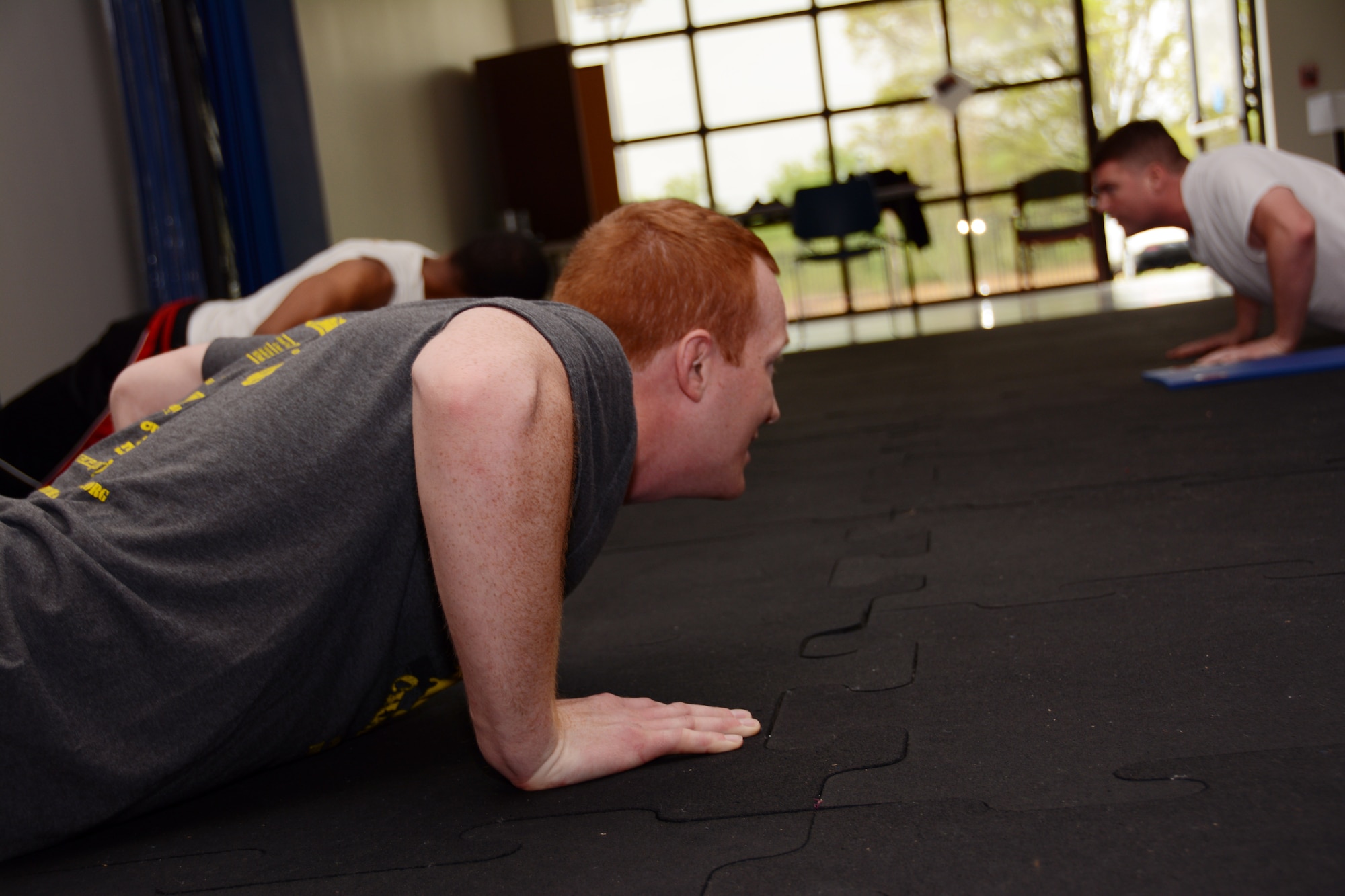 U. S. Air Force Senior Airman Cody Hilton, Fitness Specialist for 145th Force Support Squadron, leads fellow airmen through an exercise program called Beat the PT, at the North Carolina Air National Guard base, Charlotte Douglas International Airport, April 14, 2015. Beat the PT is a six week fitness program, created by Hilton, which supplies all of the tools and advice necessary in every fitness level to members wishing to improve scores on the Air Force Fitness Assessment and achieve their fitness goals. (U.S. Air National Guard photo by Master Sgt. Patricia F. Moran, 145th Public Affairs/Released)