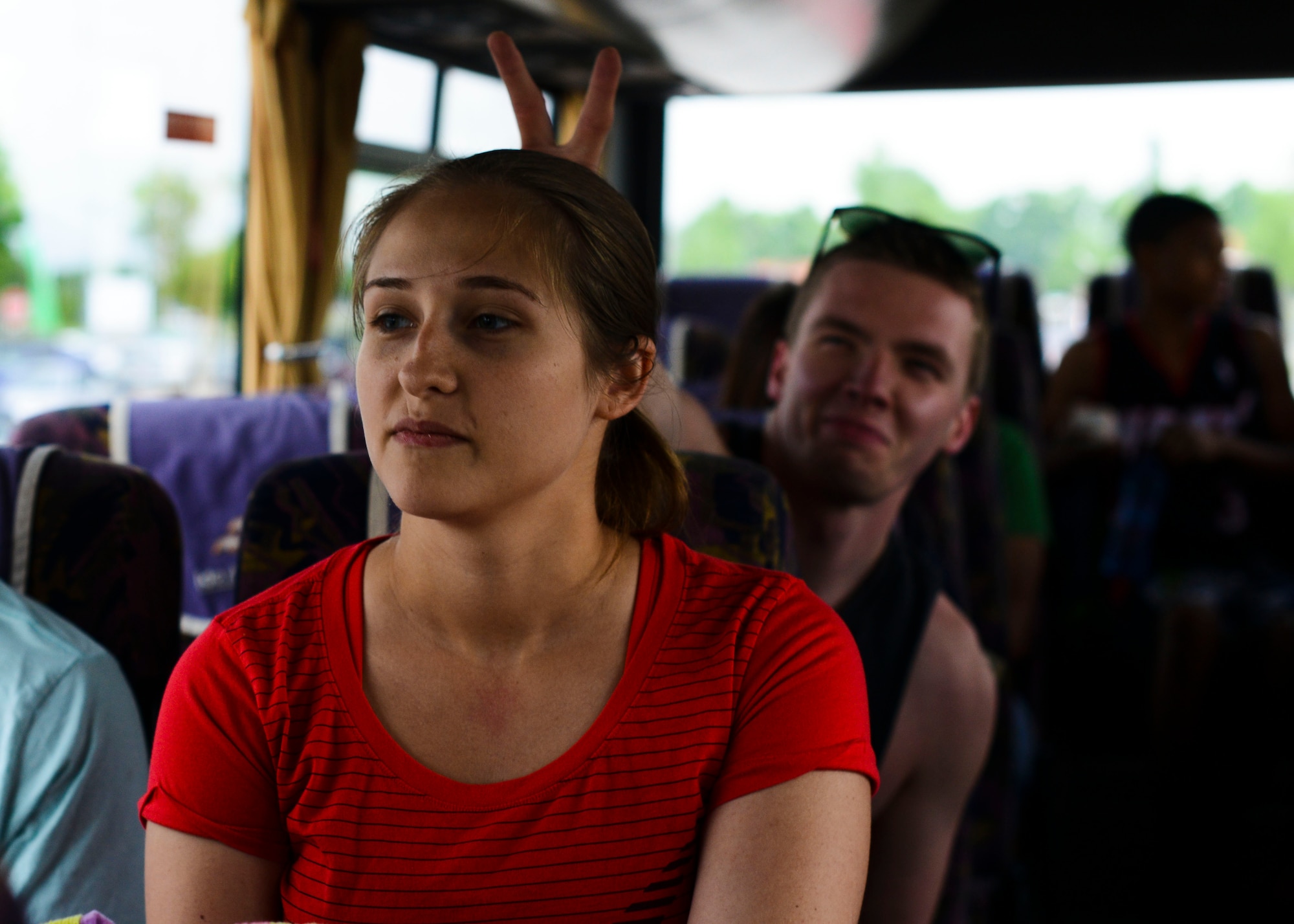U.S. Air Force Airman 1st Class Rob Daniels, 31st Medical Support Squadron medical materiel journeyman, puts “bunny ears” behind Senior Airman Megan Grose, 31st MDSS medical logistics technician before a trip off base, June 20, 2015, at Aviano Air Base, Italy. Grose and Daniels believe these trips build camaraderie within the 31st Medical Group. (U.S. Air Force photo by Senior Airman Austin Harvill/Released)