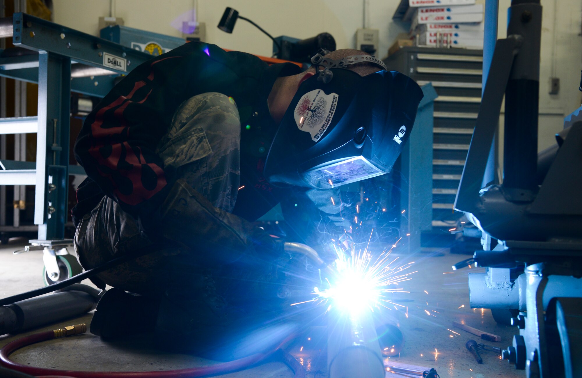 Airman 1st Class Curtis Doherty, 374th Maintenance Squadron aircraft metals technology journeyman, welds a hole on a tow bar on a B-1 platform at the fabrication shop at Yokota Air Base, Japan, June 23, 2015. The metal technology shop performs maintenance work with welding and machining equipment to keep aircraft in flight and repair equipment for various base agencies. (U.S. Air Force photo by Senior Airman David Owsianka/Released)