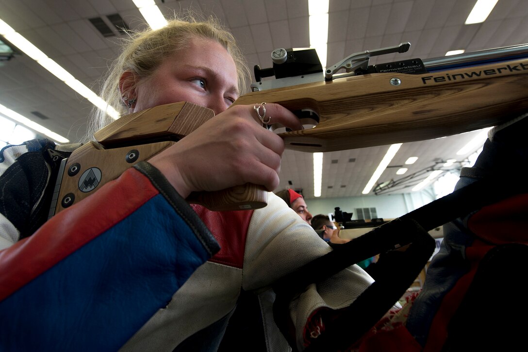 Army Reserve Spc. Chasity Kuczer teaches a rifle marksmanship technique using her cane during the Army Trials for the 2015 Department of Defense Warrior Games at Fort Bliss in El Paso, Texas, March 30, 2015. Athletes in the trials competed for a spot on the Army’s team in the 2015 Department of Defense Warrior Games. DoD photo by EJ Hersom