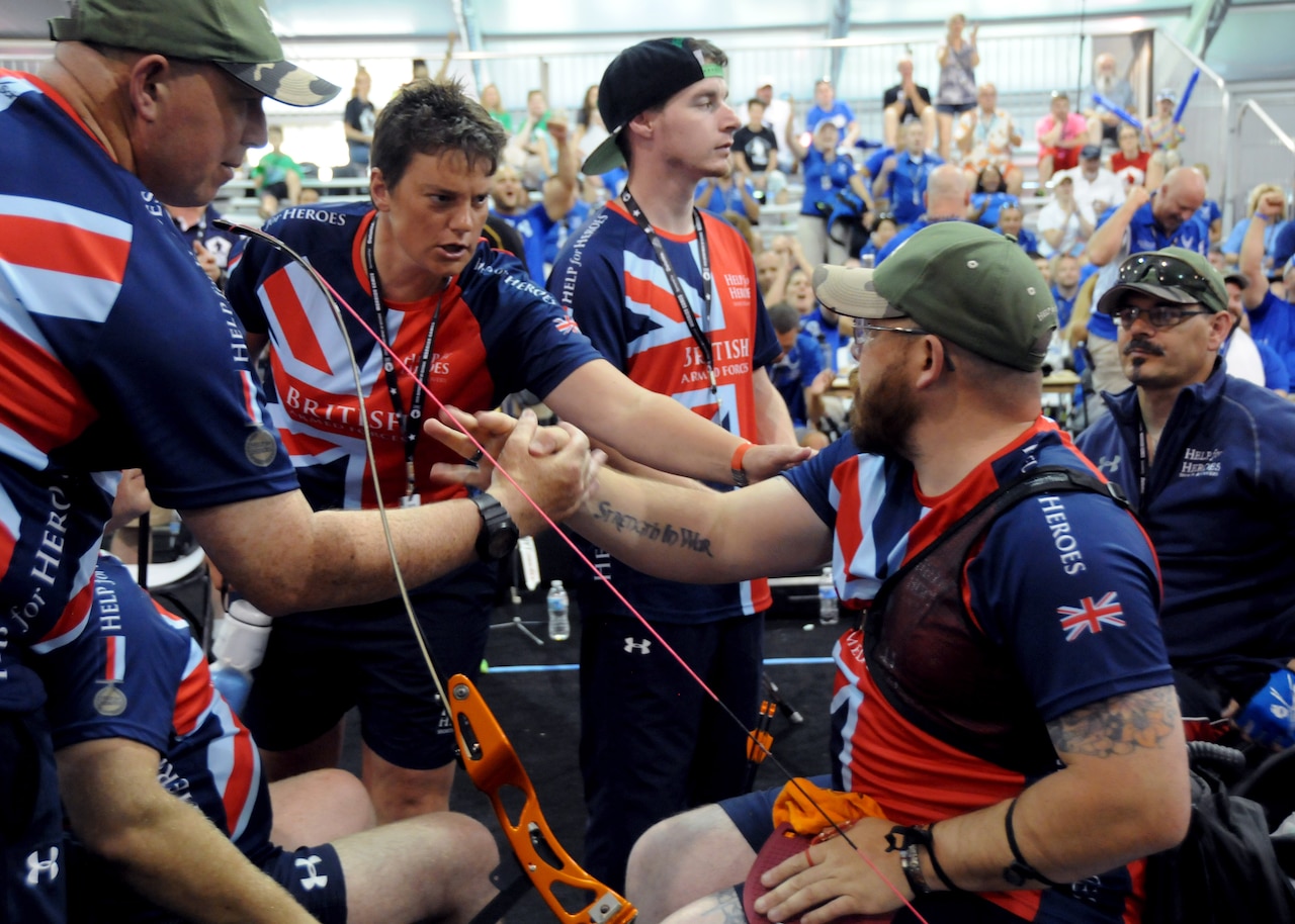 Medically retired British Army Cpl. David "H" Hubber receives some last-minute tips from his coach during the 2015 DoD Warrior Games at Marine Corps Base Quantico, Va., June 22, 2015. He earned a bronze medal with the British Forces team in the team recurve shooting event. DoD photo by Shannon Collins