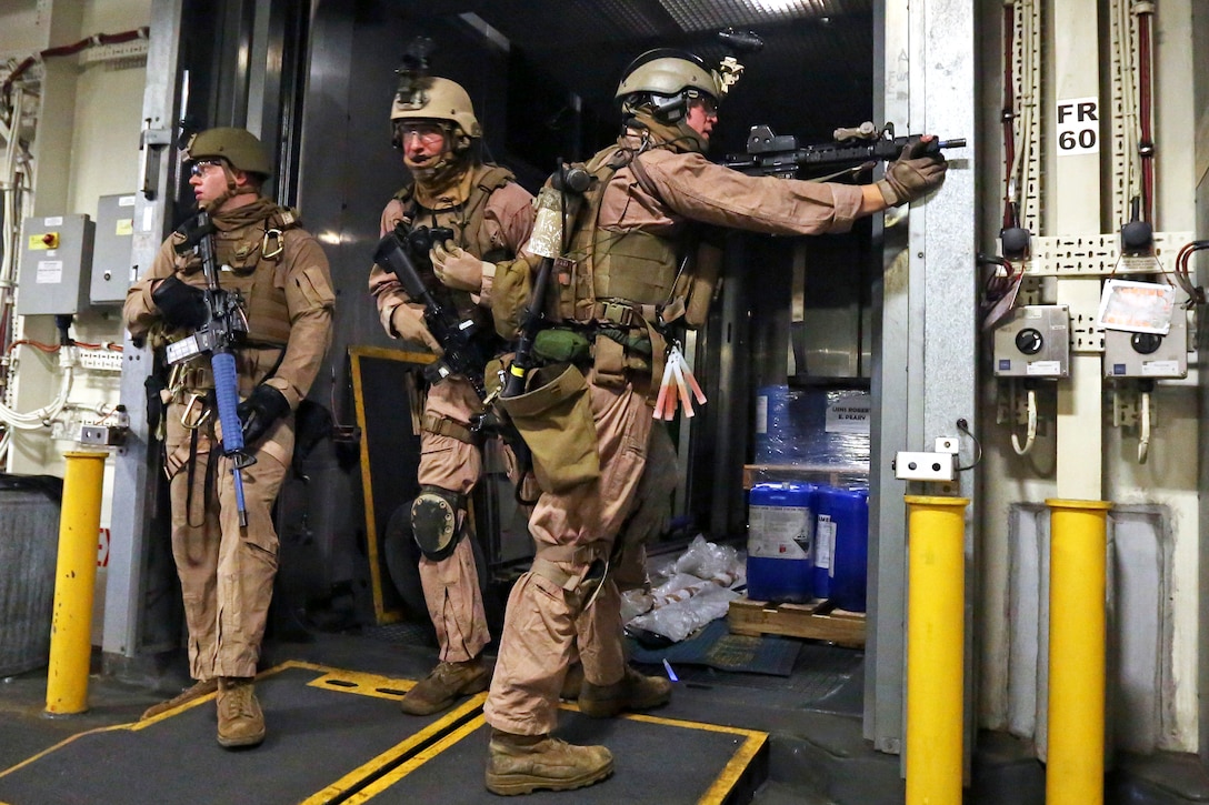 U.S. Marines clear a passageway during visit, board, search and seizure ...