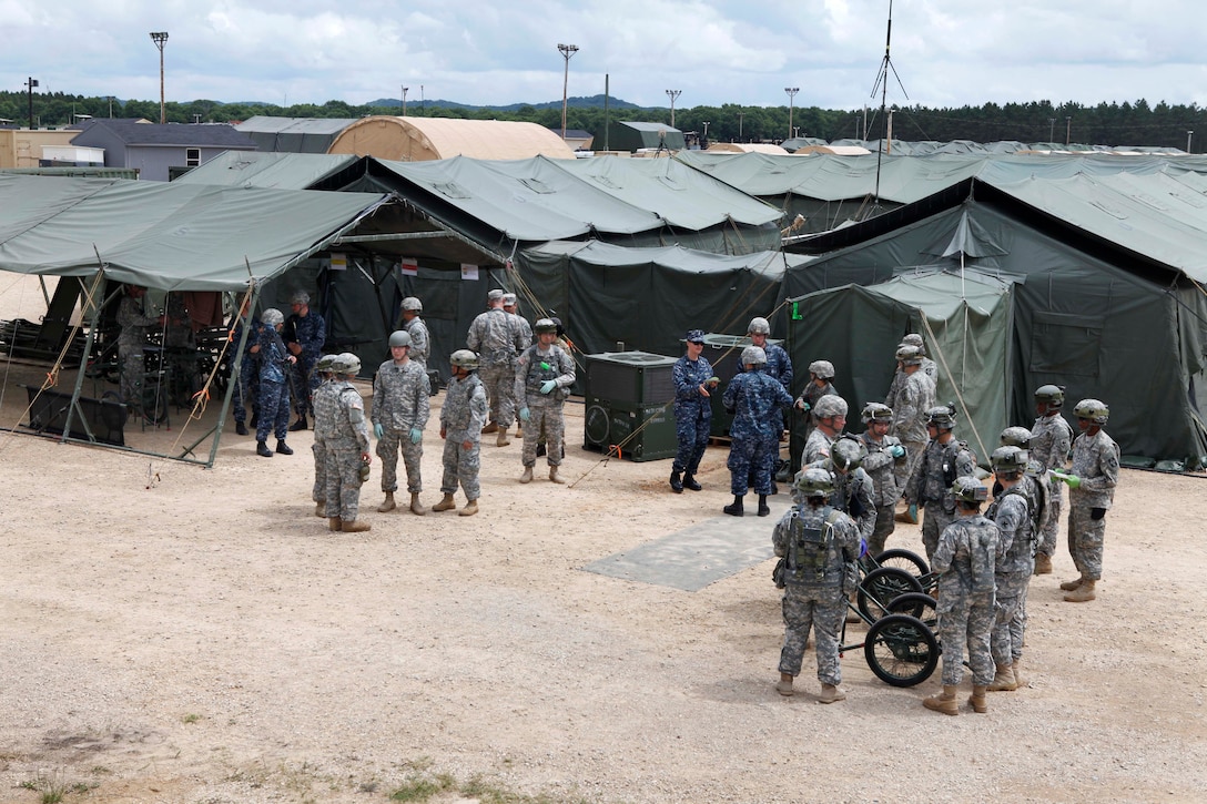 U.S. Army and Navy reservists participate in emergency evacuation exercise Global Medic at Fort McCoy, Wis., June 14, 2015. The soldiers are assigned to the 94th Combat Support Hospital and the sailors are assigned to Expeditionary Medical Facility Great Lakes One. Global Medic is the premier medical field training event in the Department of Defense and is the only joint accredited exercise conceived, planned and executed by Army Reserve soldiers.