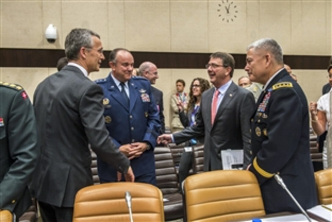 U.S. Defense Secretary Ash Carter, second from right, speaks with NATO Secretary General Jens Stoltenberg, far left, U.S. Air Force Gen. Philip M. Breedlove, NATO's supreme allied commander for Europe and commander of U.S.  European Command, and U.S. Army Gen. John F. Campbell, commander of NATO forces in Afghanistan, at NATO headquarters in Brussels, June 25, 2015.
