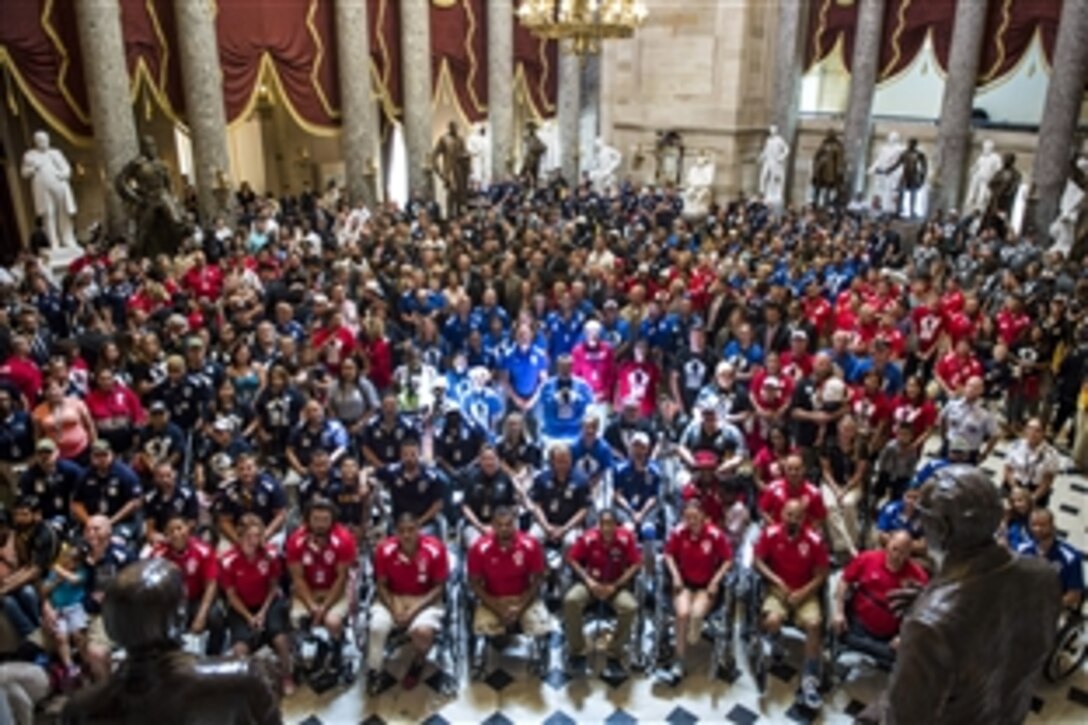 Military athletes participating in the 2015 Department of Defense Warrior Games pose for a photo with U.S. representatives during a tour of the U.S. Capitol in Washington, D.C., June 24, 2015. About 250 athletes are competing in the games, which feature eight adaptive sports for wounded, ill, and injured service members and veterans from the Army, Marine Corps, Navy/Coast Guard, Air Force, Special Operations Command and British forces.