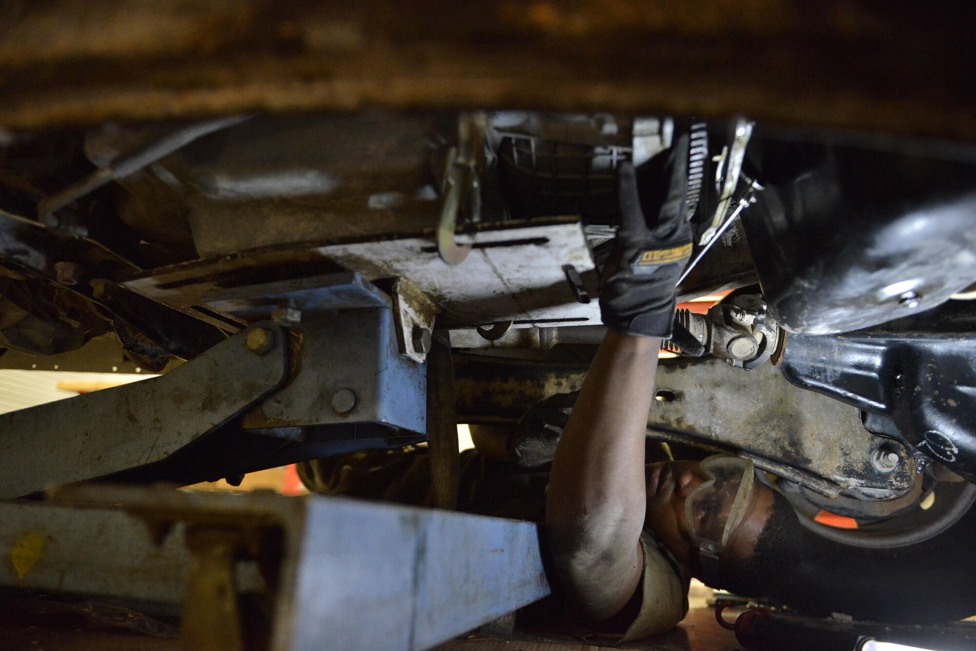 Senior Airman Joseph Heard, 379th Expeditionary Logistics Readiness Squadron vehicle maintenance, replaces part of a transmission to keep the vehicle serviceable for deployed personnel June 24, 2015 Al Udeid Air Base, Qatar. Vehicle management maintains almost 1,000 government owned vehicles and manages another 750 leased vehicles for Al Udeid. (U.S. Air Force photo/ Staff Sgt. Alexandre Montes)